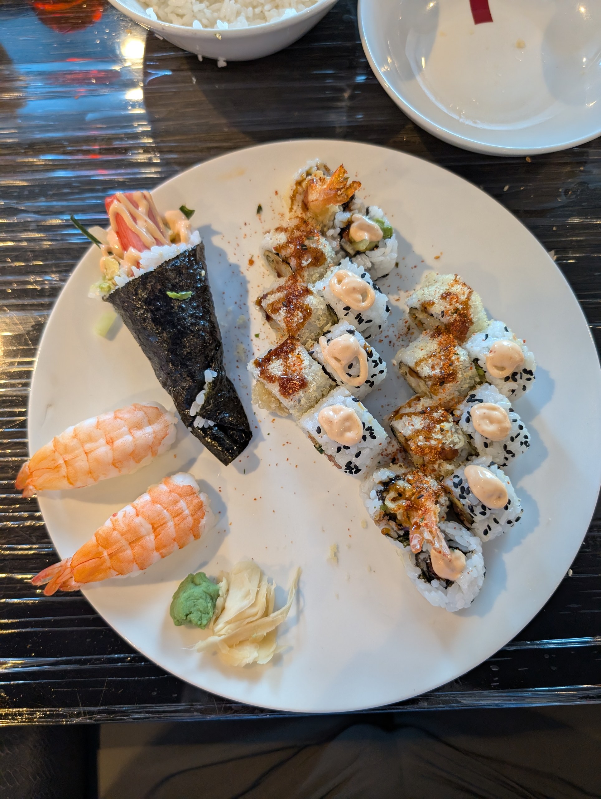 Sushi platter with shrimp nigiri, hand roll, and specialty rolls topped with spicy mayo at Izumi, the sushi restaurant on Harmony of the Seas.