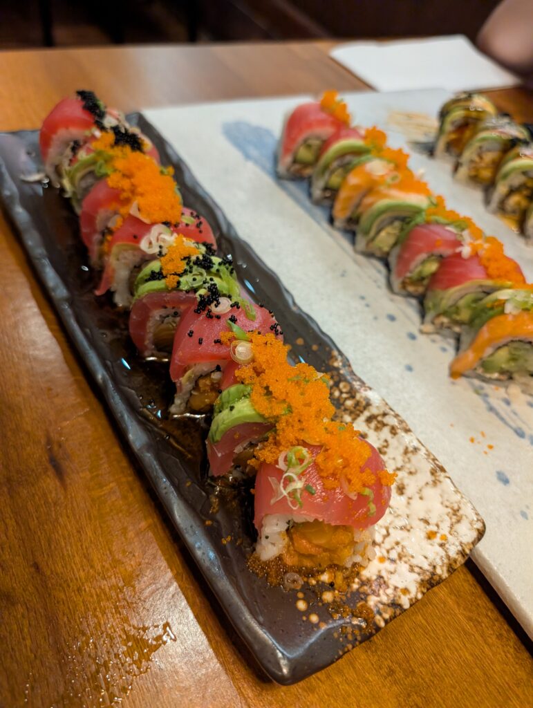 All four sushi rolls at Tekka Sushi plated and lined up on the table