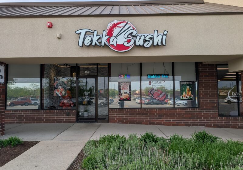 Tekka Sushi storefront with bold red and white sign, located in a strip mall in Elk Grove Village, Illinois
