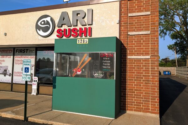 Ari Sushi storefront on Elmhurst Road in Des Plaines, stylized fish logo and red SUSHI text above the entrance