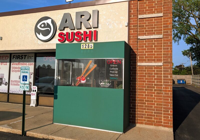 Ari Sushi storefront on Elmhurst Road in Des Plaines, stylized fish logo and red SUSHI text above the entrance