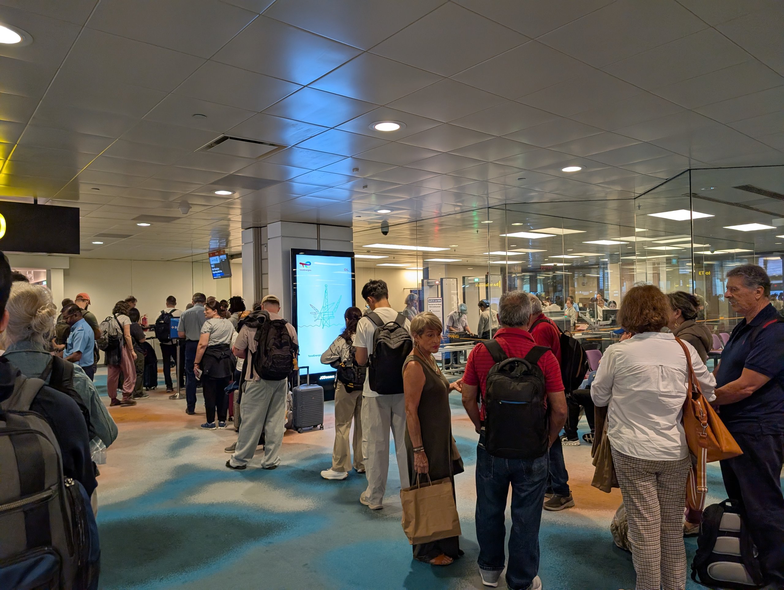 Crowd of travelers queuing for gate side security screening at Changi Airport Terminal 2