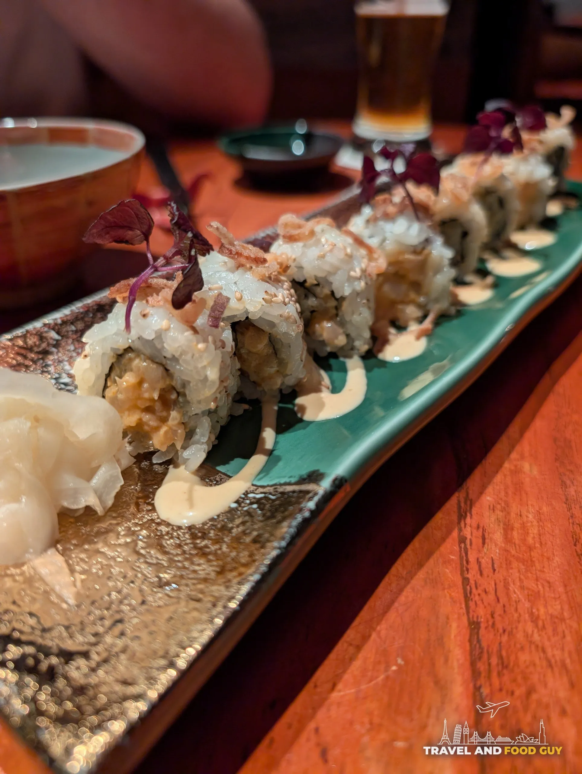 The Spicy Yellowtail maki roll at KOMA Singapore, topped with crispy fried shallots and spicy mayo.