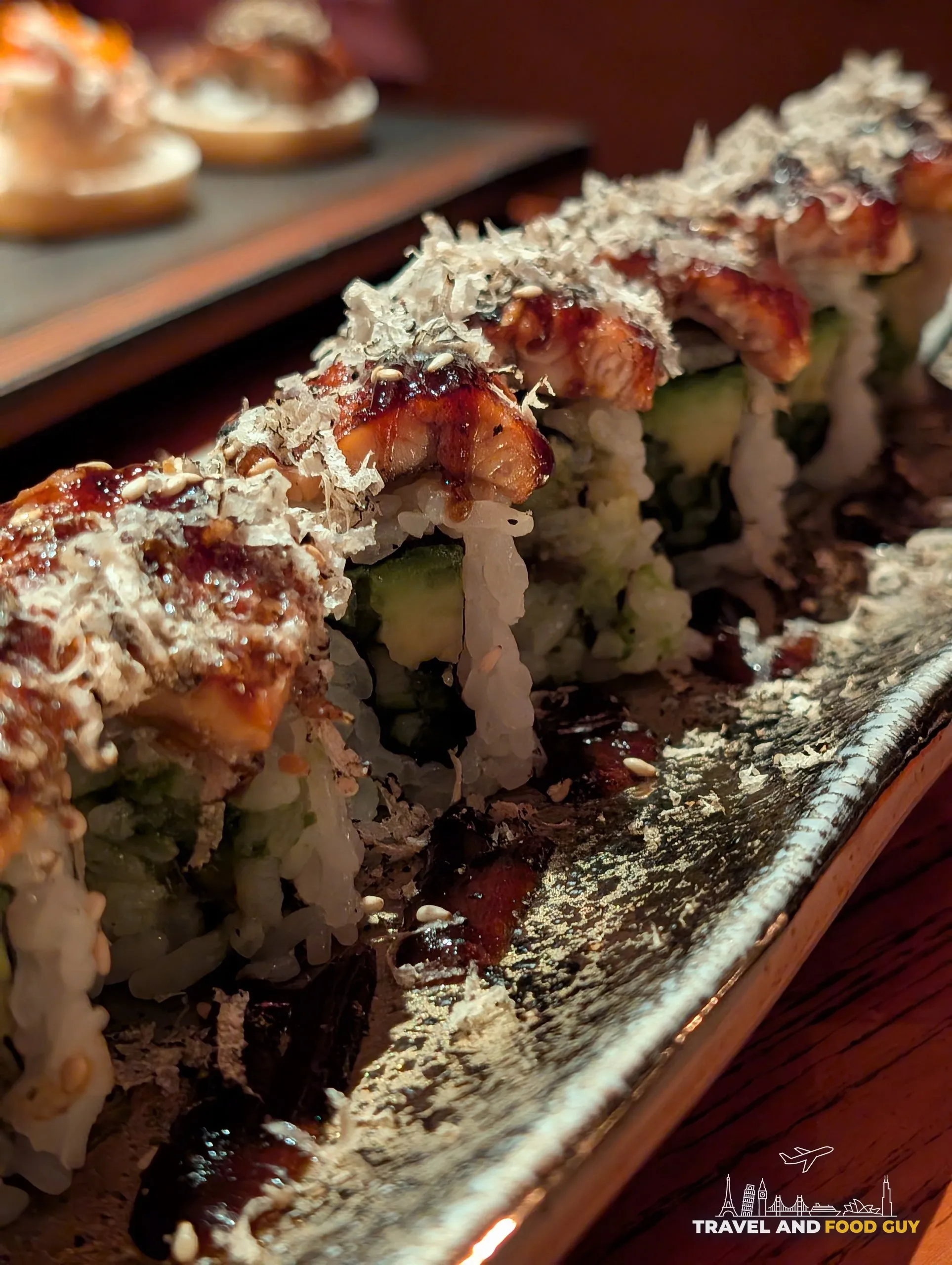The Truffle Unagi roll at KOMA Singapore, glazed with sweet soy and topped with bonito flakes.