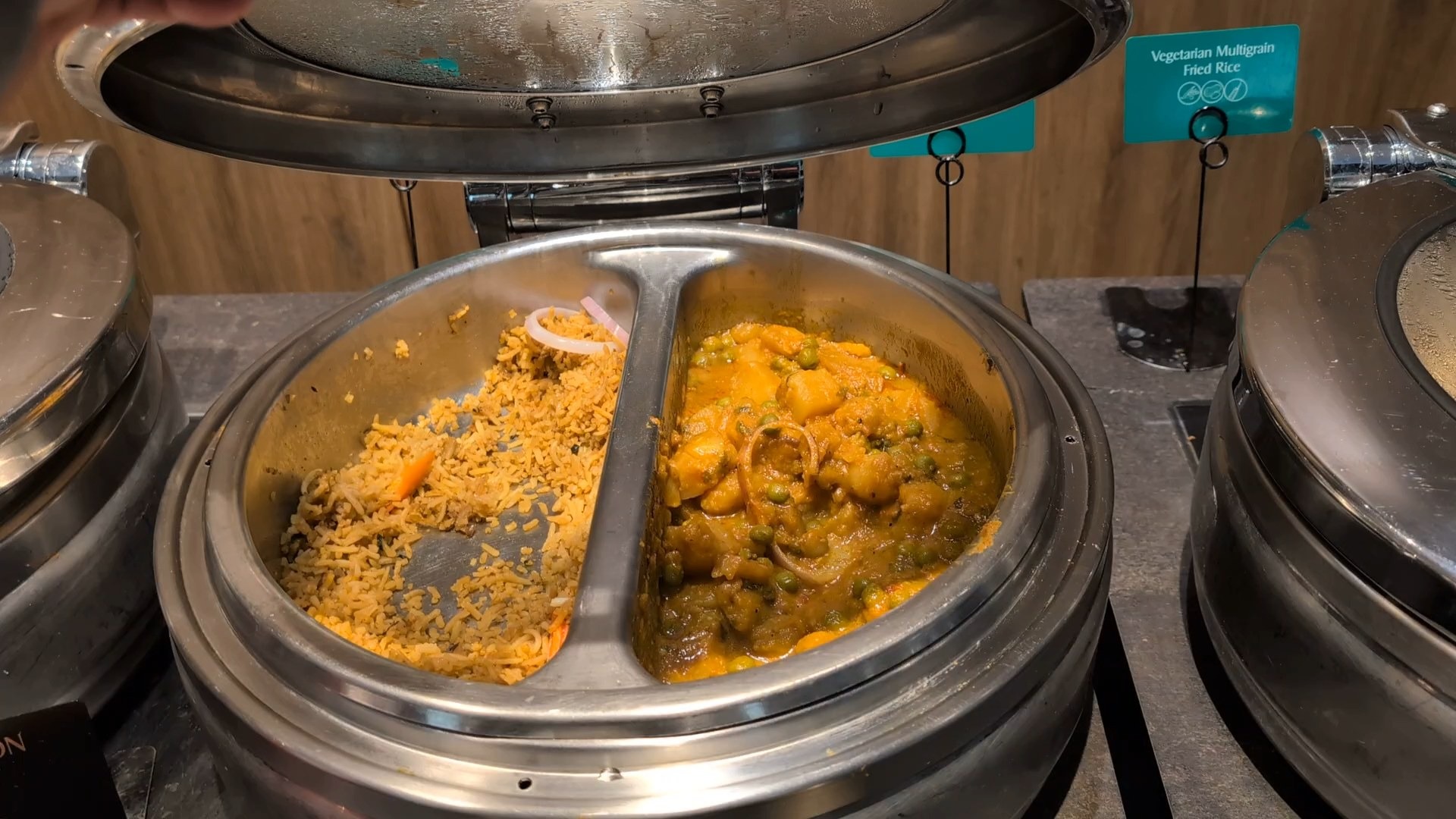 Aloo mattar curry and vegetarian multigrain fried rice in a split steam tureen at the Indian station.