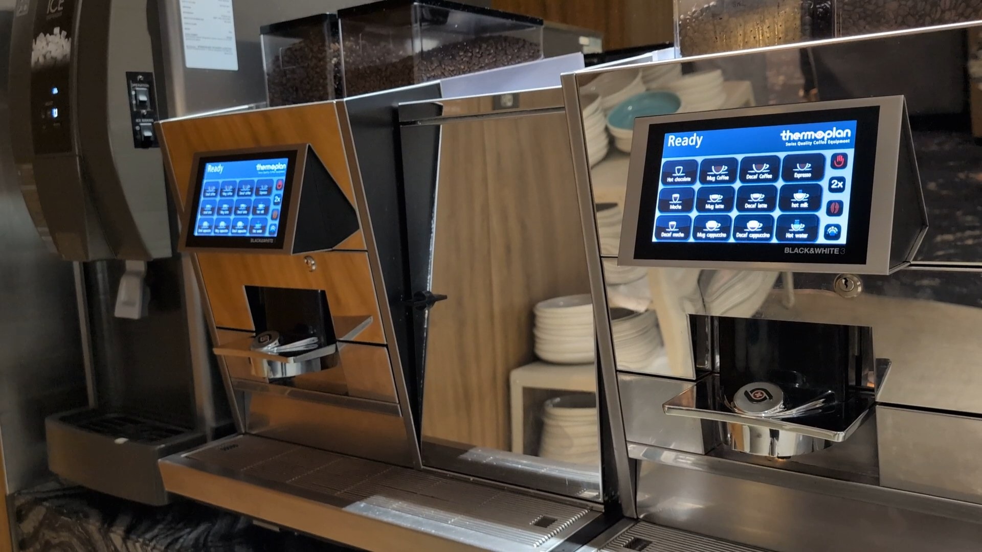 Two Thermoplan Black and White automatic espresso machines at the KrisFlyer Gold Lounge coffee station.