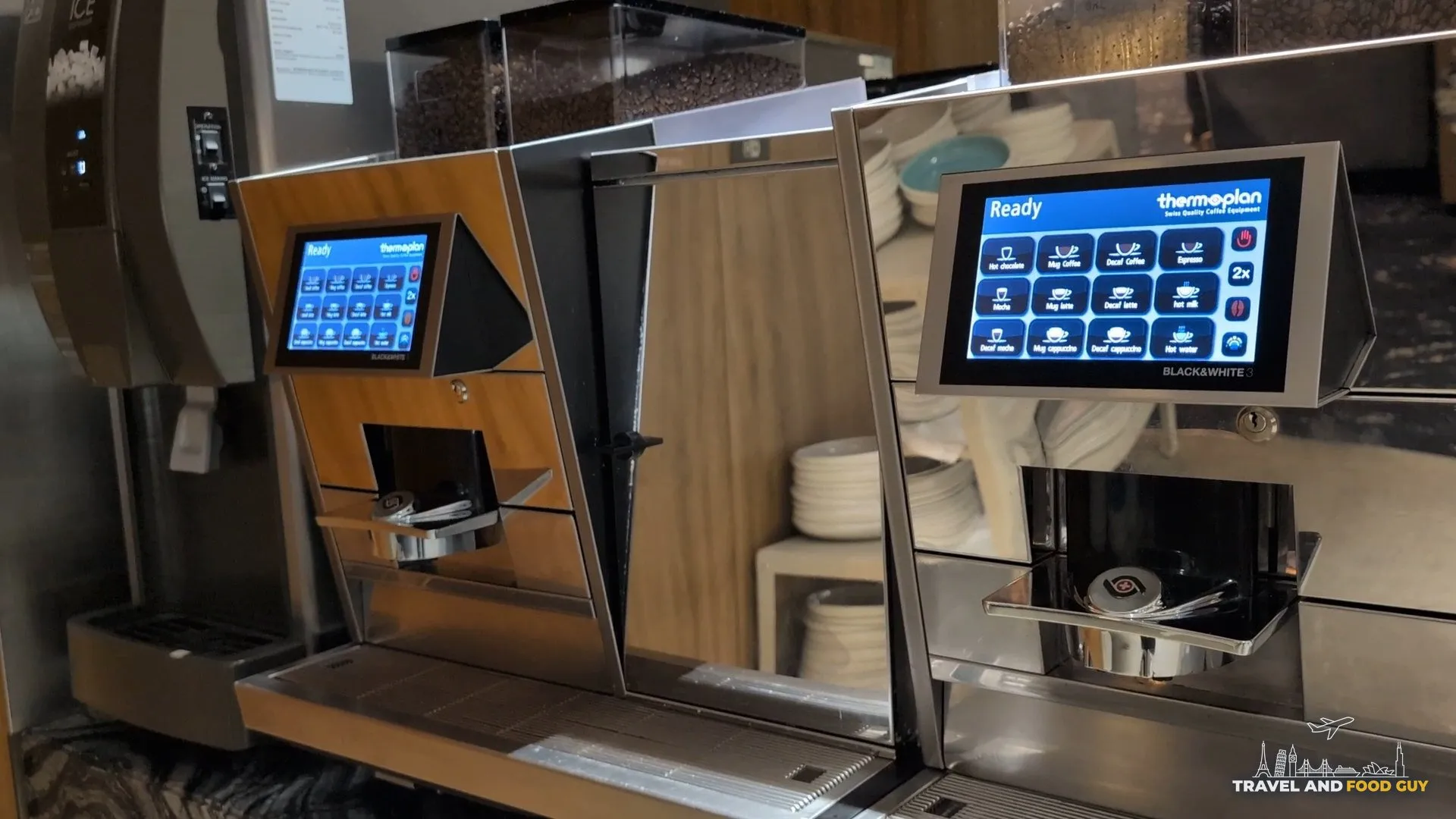 Two Thermoplan Black and White automatic espresso machines at the KrisFlyer Gold Lounge coffee station.