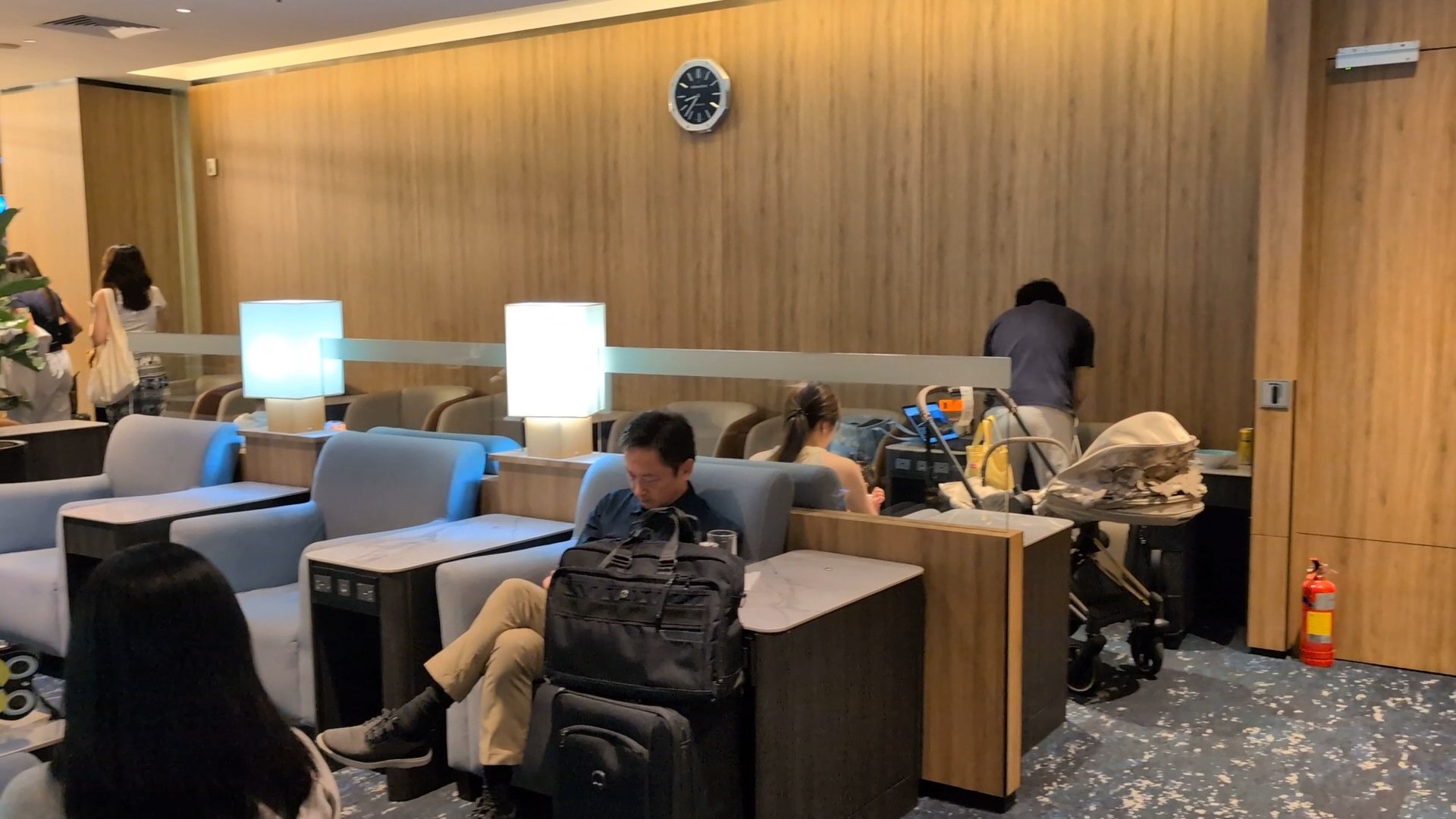 Blue armchair pods and cube lamps in the family seating area, with a stroller parked nearby.