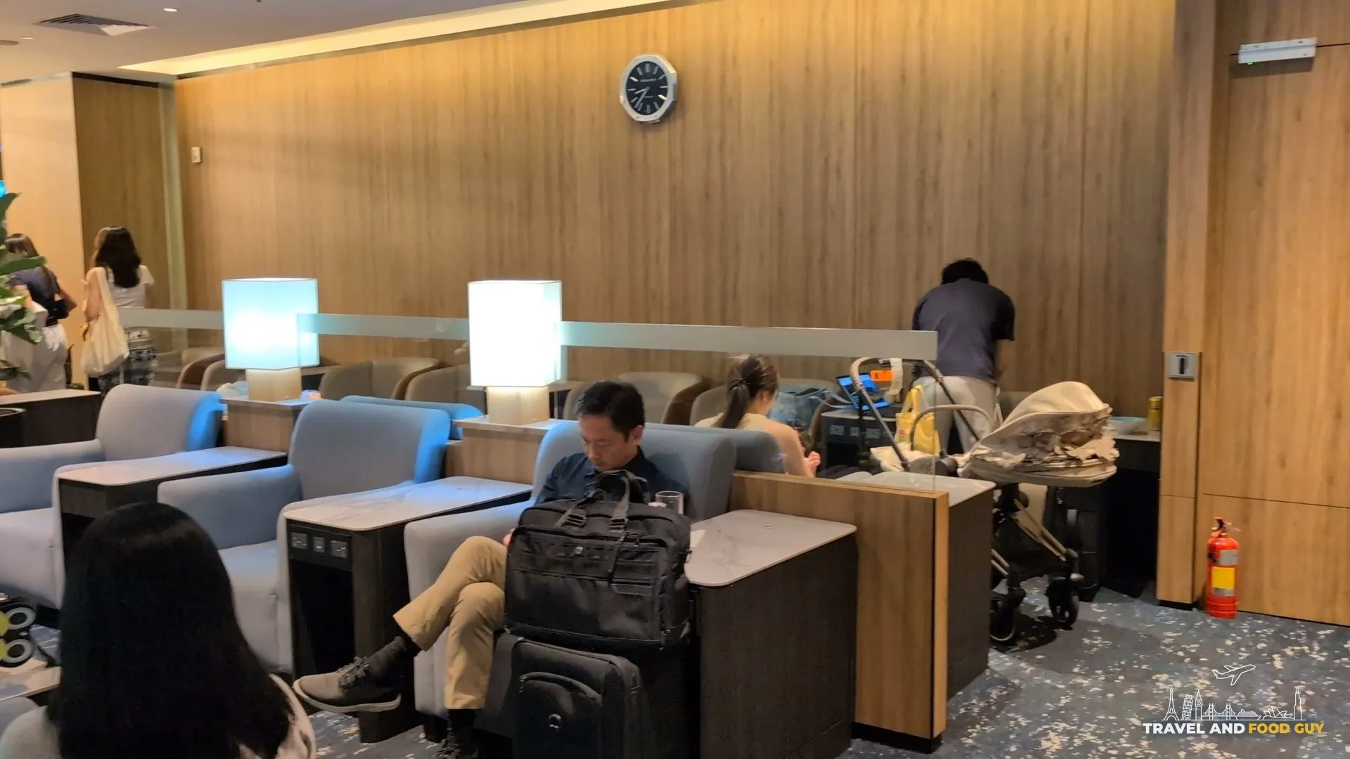 Blue armchair pods and cube lamps in the family seating area, with a stroller parked nearby.