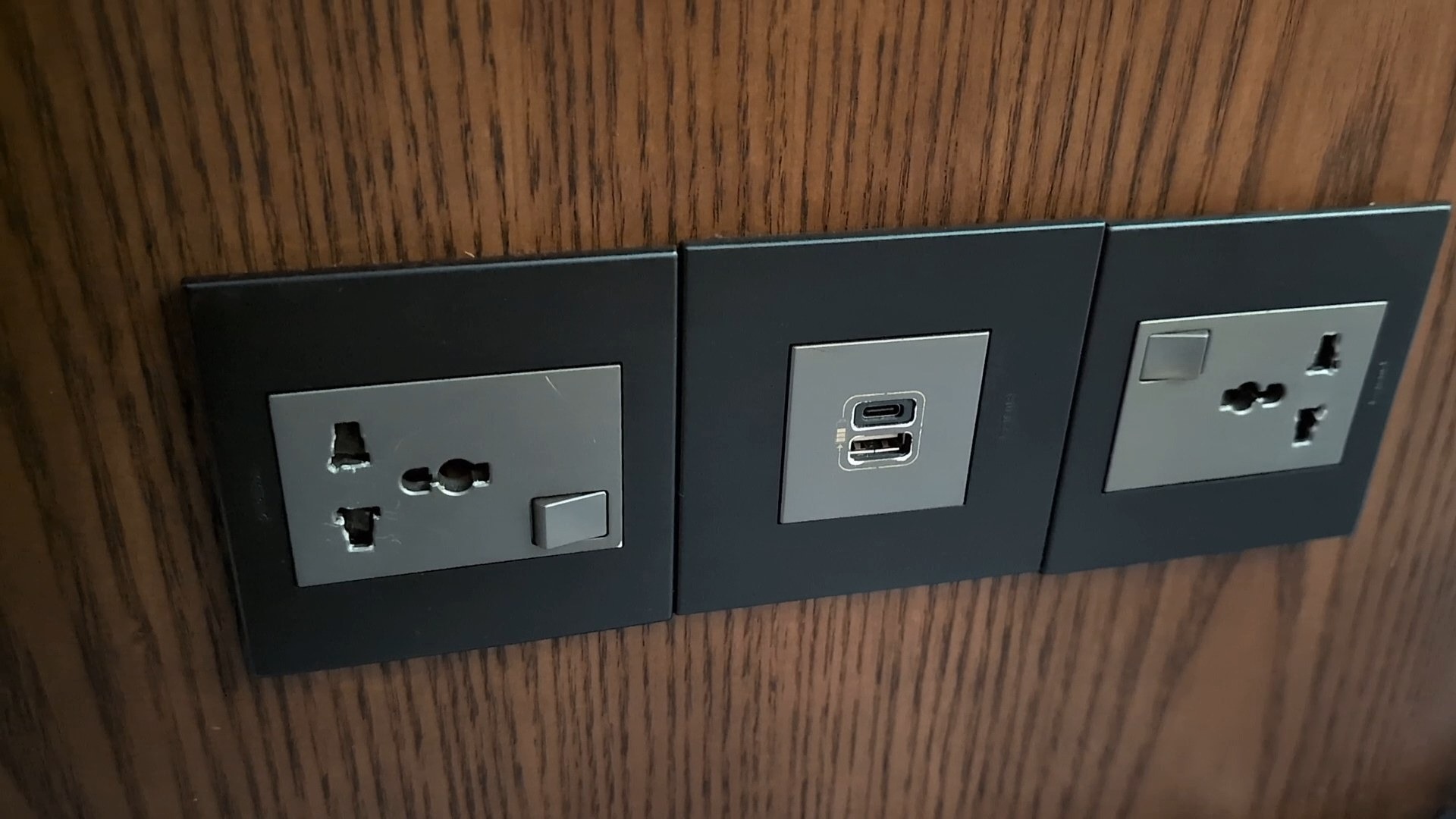Universal AC outlet plus USB-A and USB-C combo at a seat in the KrisFlyer Gold Lounge.