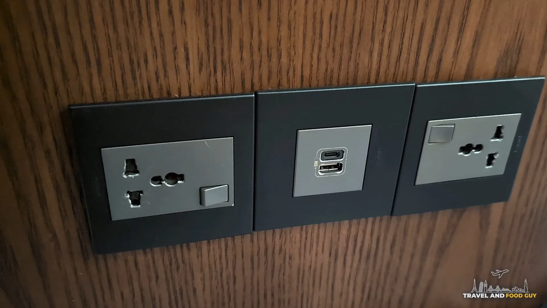 Universal AC outlet plus USB-A and USB-C combo at a seat in the KrisFlyer Gold Lounge.