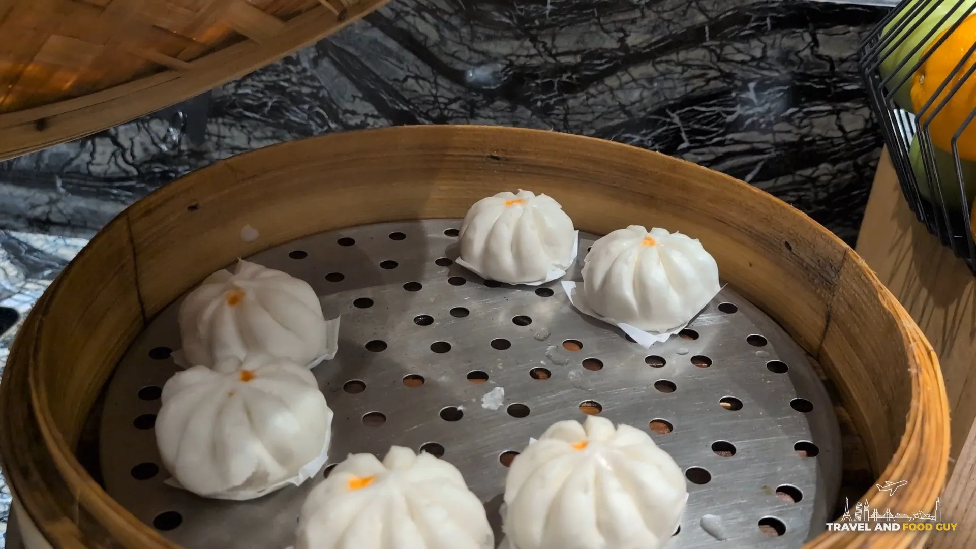 Steamed baos in a bamboo steamer at the KrisFlyer Gold Lounge dim sum line.