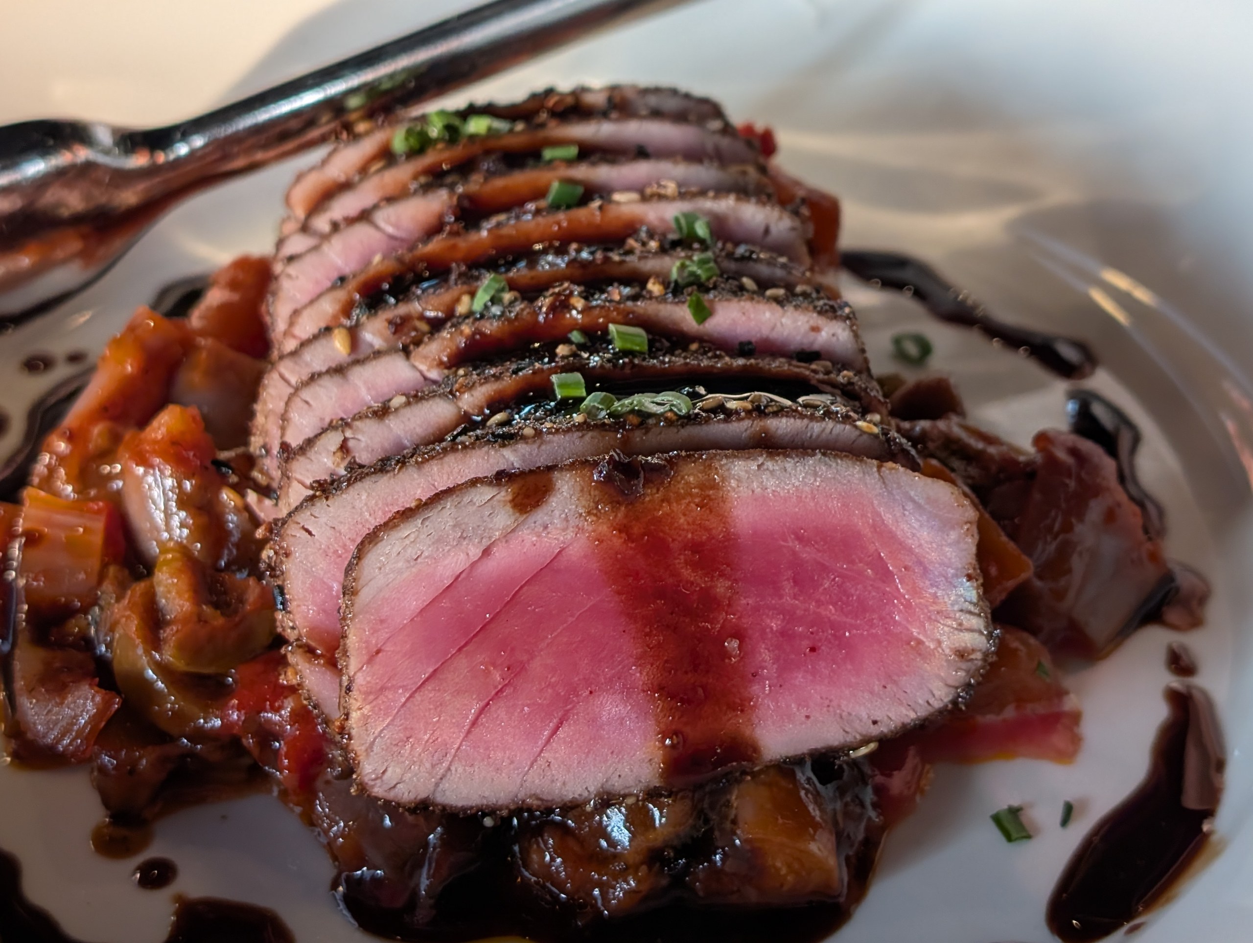 Bluefin Tuna at LAGO Lake Zurich with peppercorn crust and rare pink interior over caponata