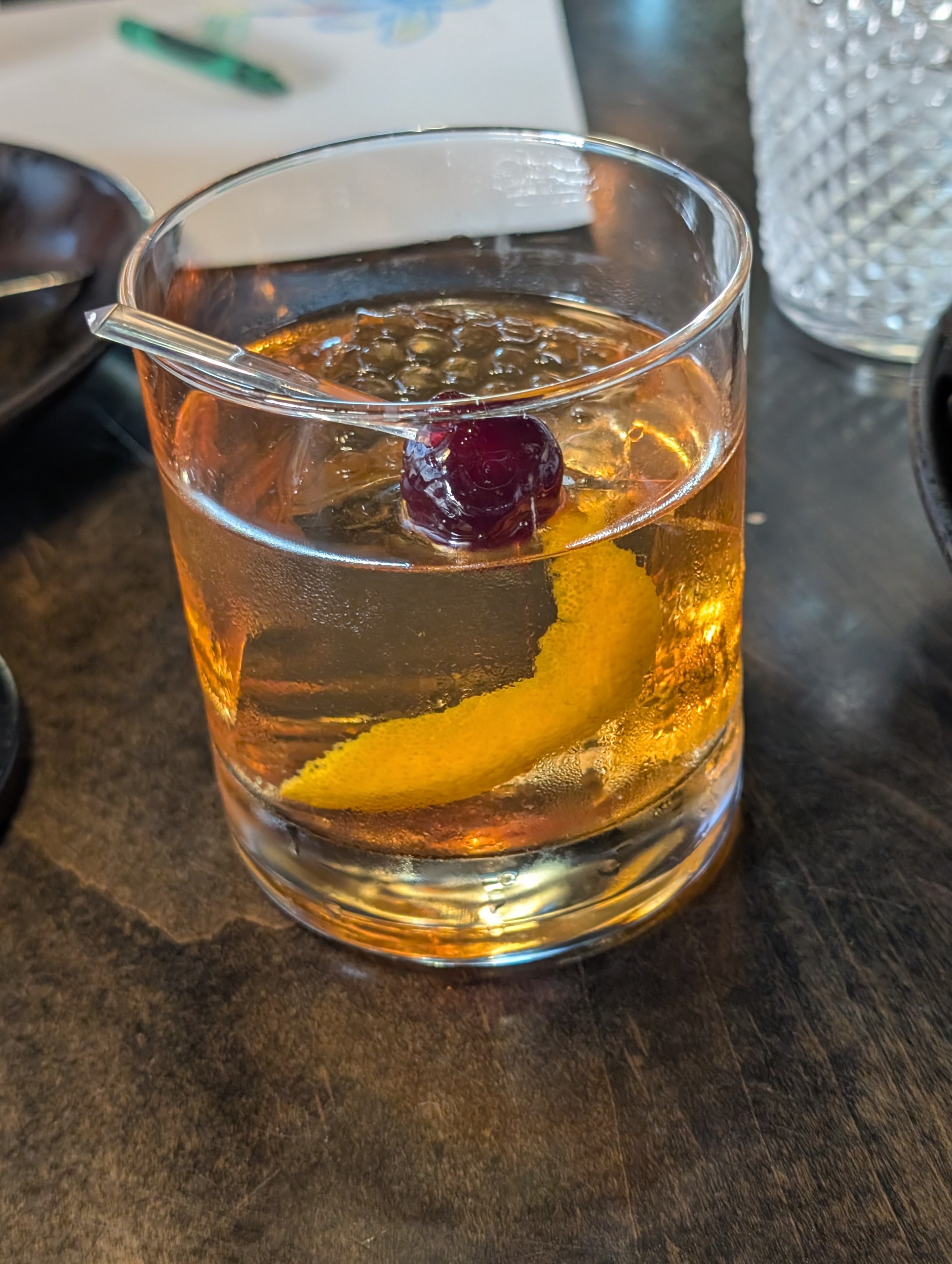 Vika's Buffalo Trace Old Fashioned at LAGO Lake Zurich, served on a single large clear ice cube with Luxardo cherries and an orange peel