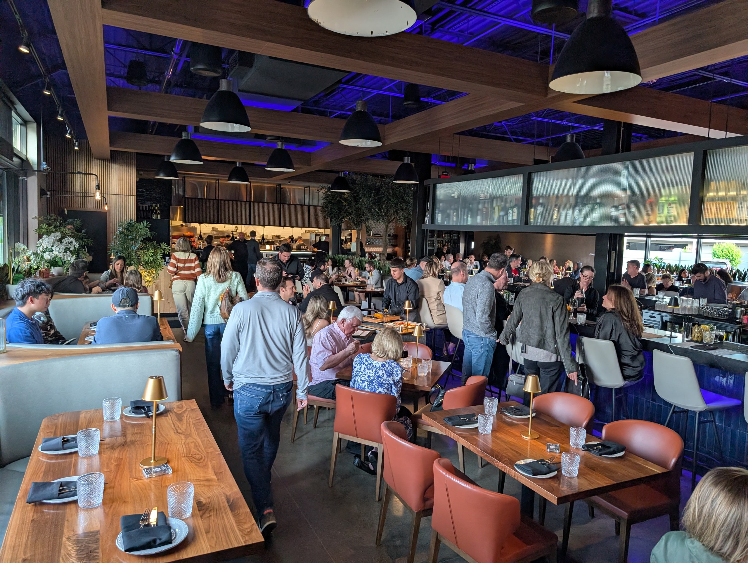 Busy dining room at LAGO Lake Zurich on a weekend night with the open kitchen at the back