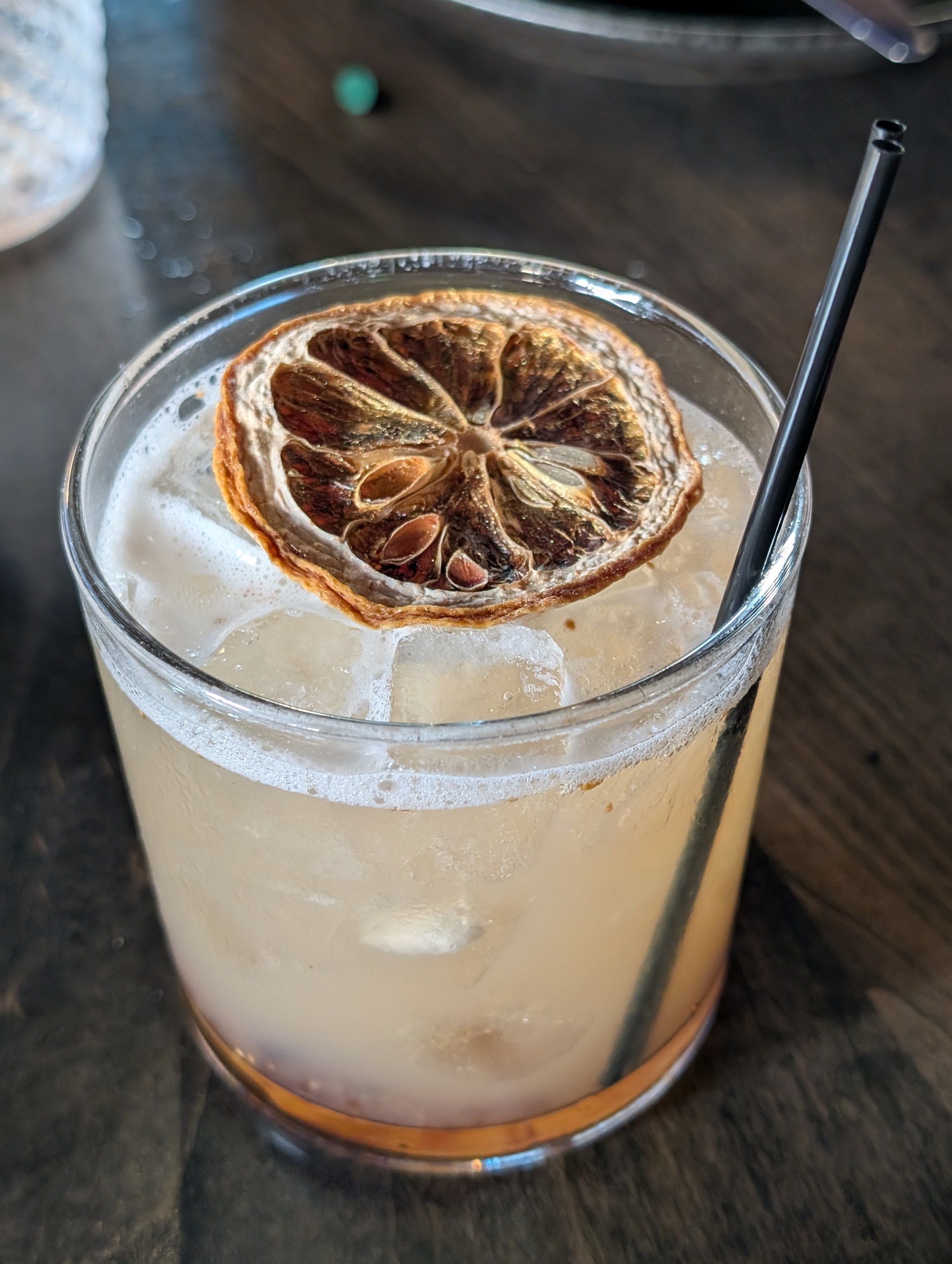 The Oro Puro cocktail at LAGO Lake Zurich, Yellowstone bourbon with St. George spiced pear, fig jam, and lemon, garnished with a dried citrus wheel