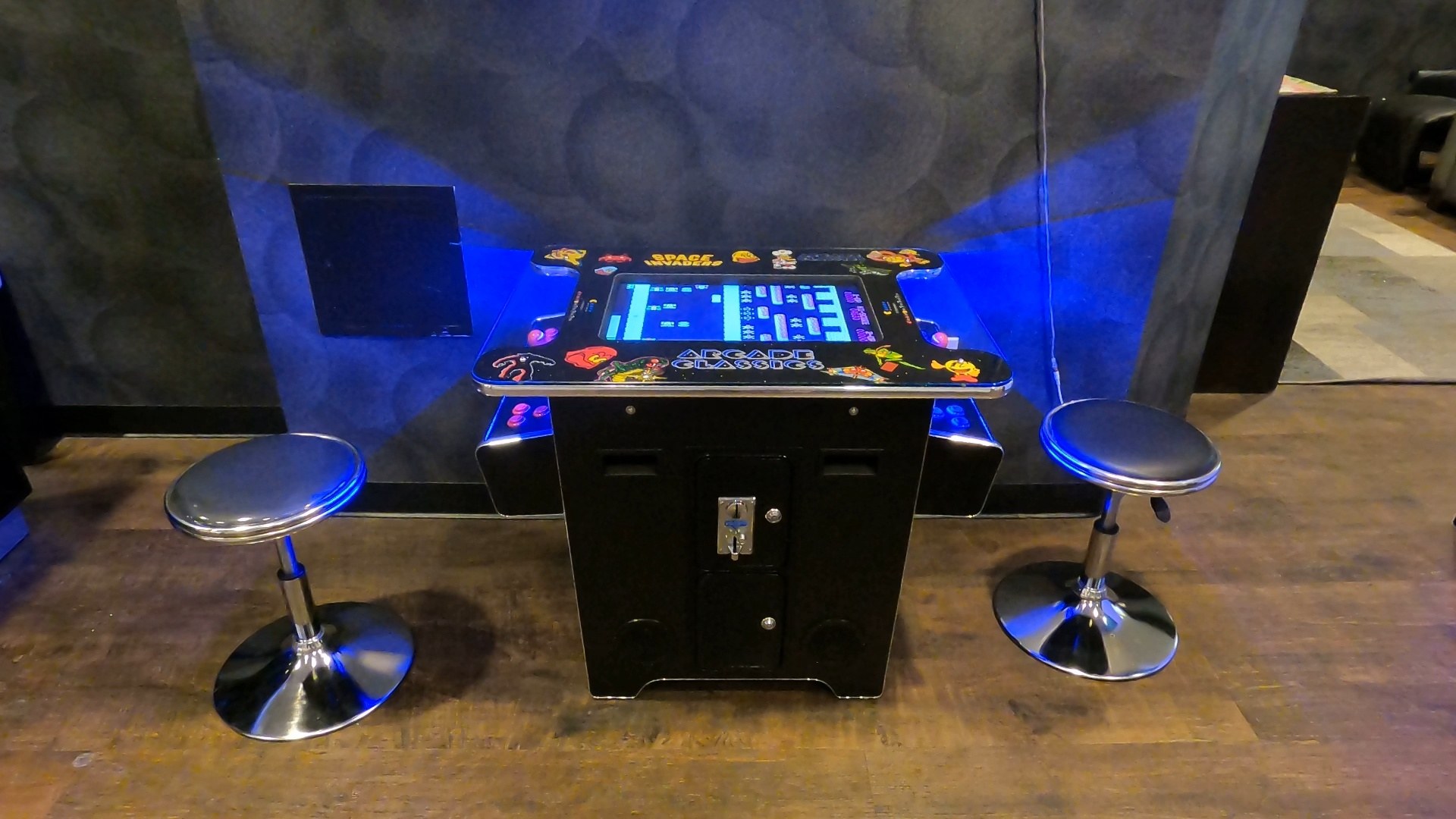 Classic arcade tabletop game with two bar stools in the activities room at the Marriott Grand Chateau Las Vegas