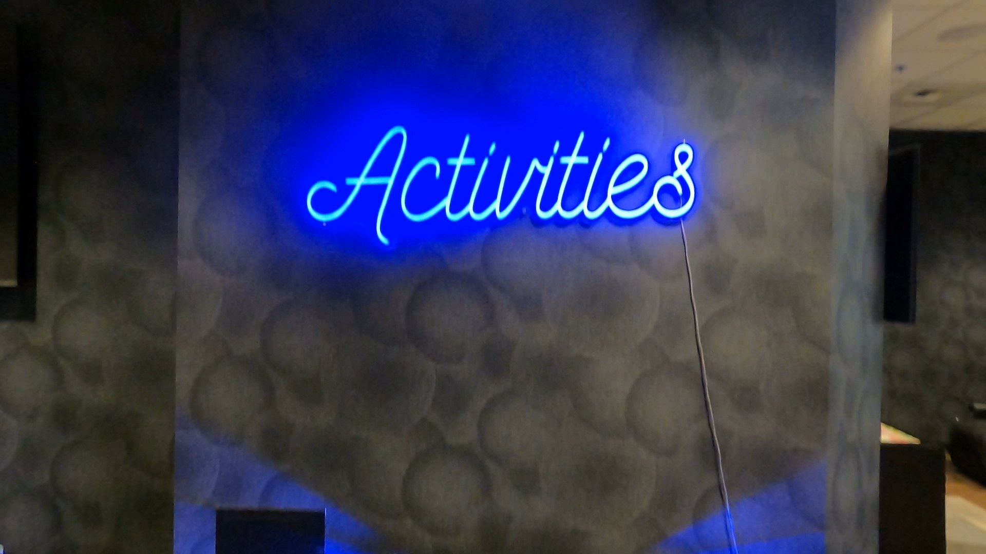 Blue neon Activities sign on a textured wall at the Marriott Grand Chateau Las Vegas
