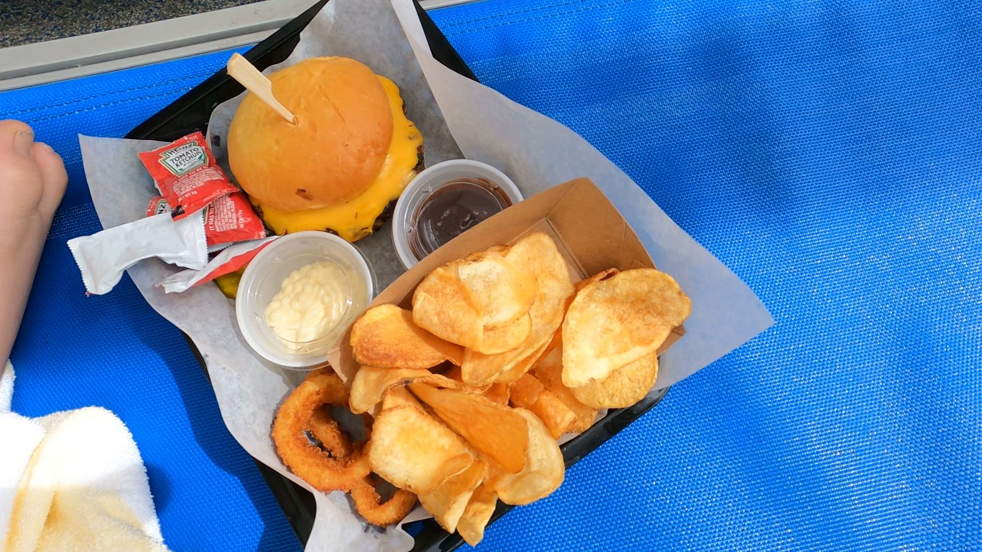 Cheeseburger with onion rings and chips at the Marriott Grand Chateau pool bar
