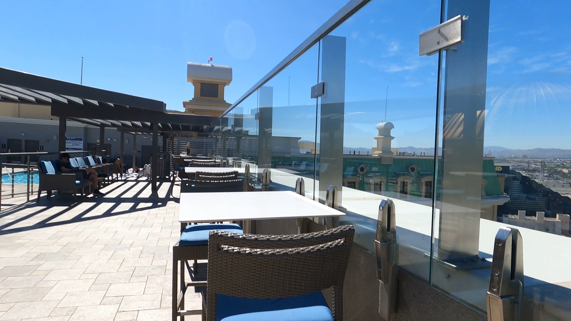 Rooftop dining area at the Marriott Grand Chateau Las Vegas with glass railing and Strip view
