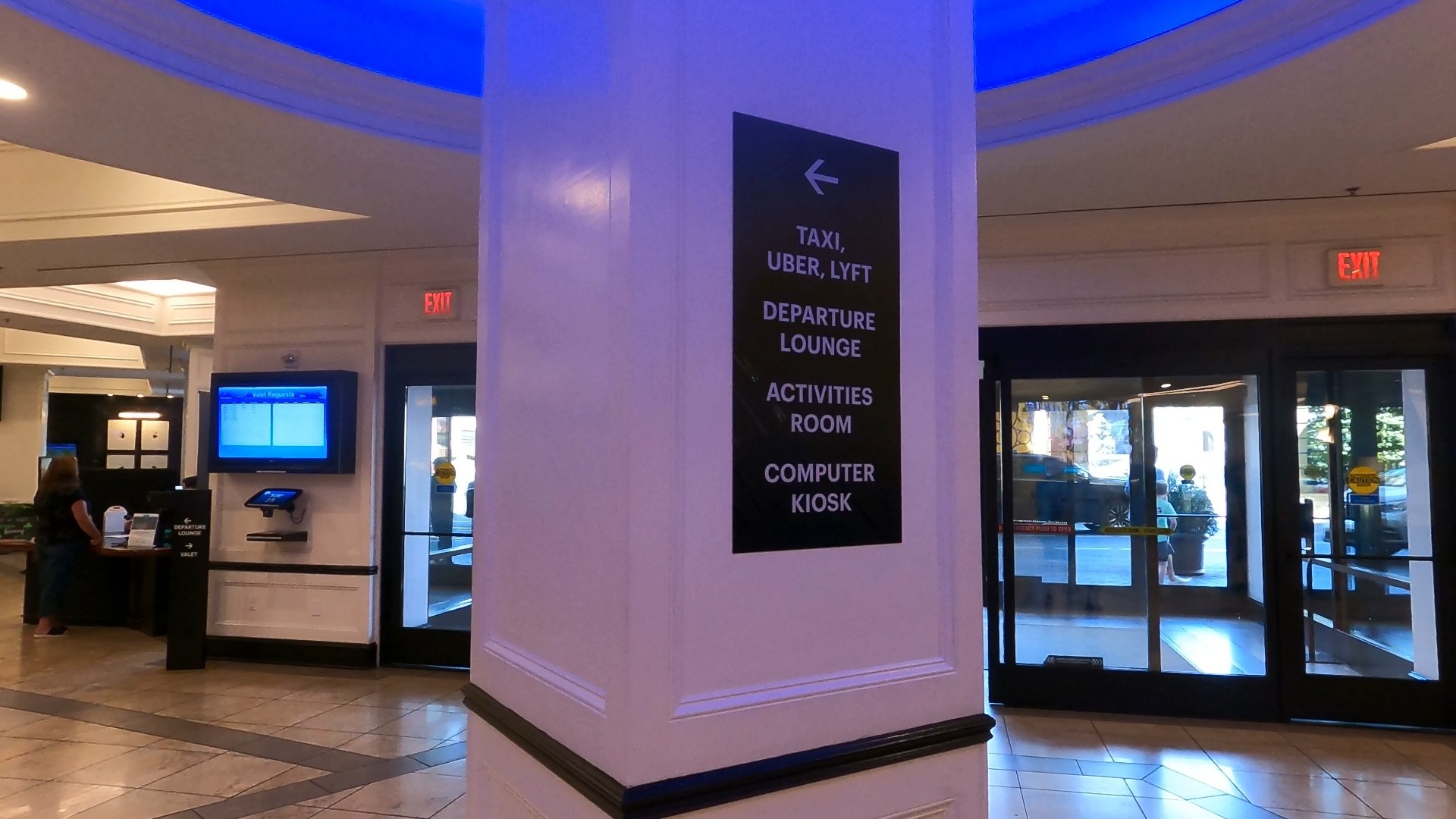 Directional sign in the Marriott Grand Chateau sky lobby pointing to taxi Uber Lyft, departure lounge, activities room, and computer kiosk