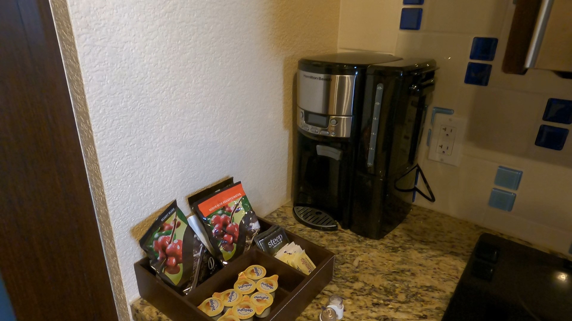 Coffee maker and tea station with K-cups and creamers on the granite counter in the Marriott Grand Chateau two-bedroom suite