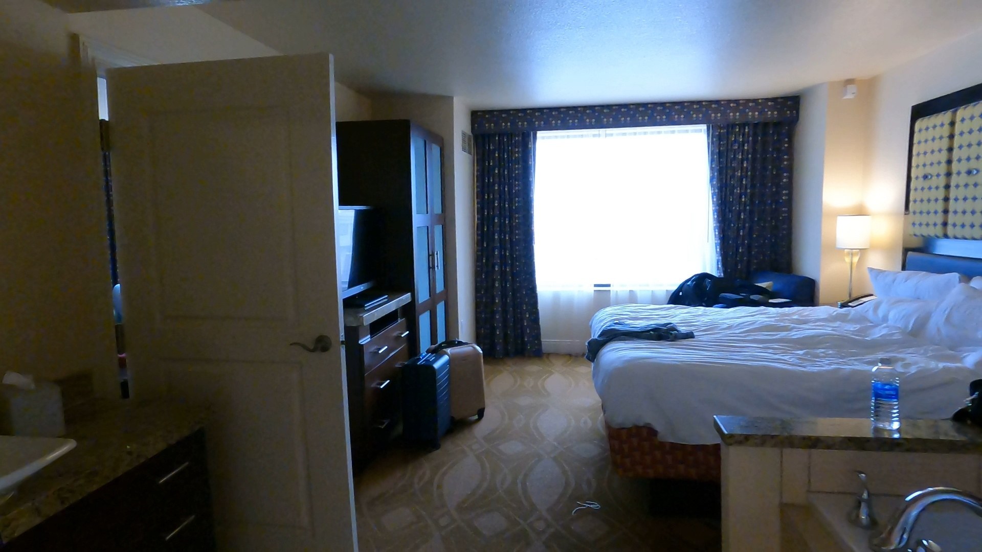 Master bedroom in the Marriott Grand Chateau two-bedroom suite with king bed, window, wardrobe and TV
