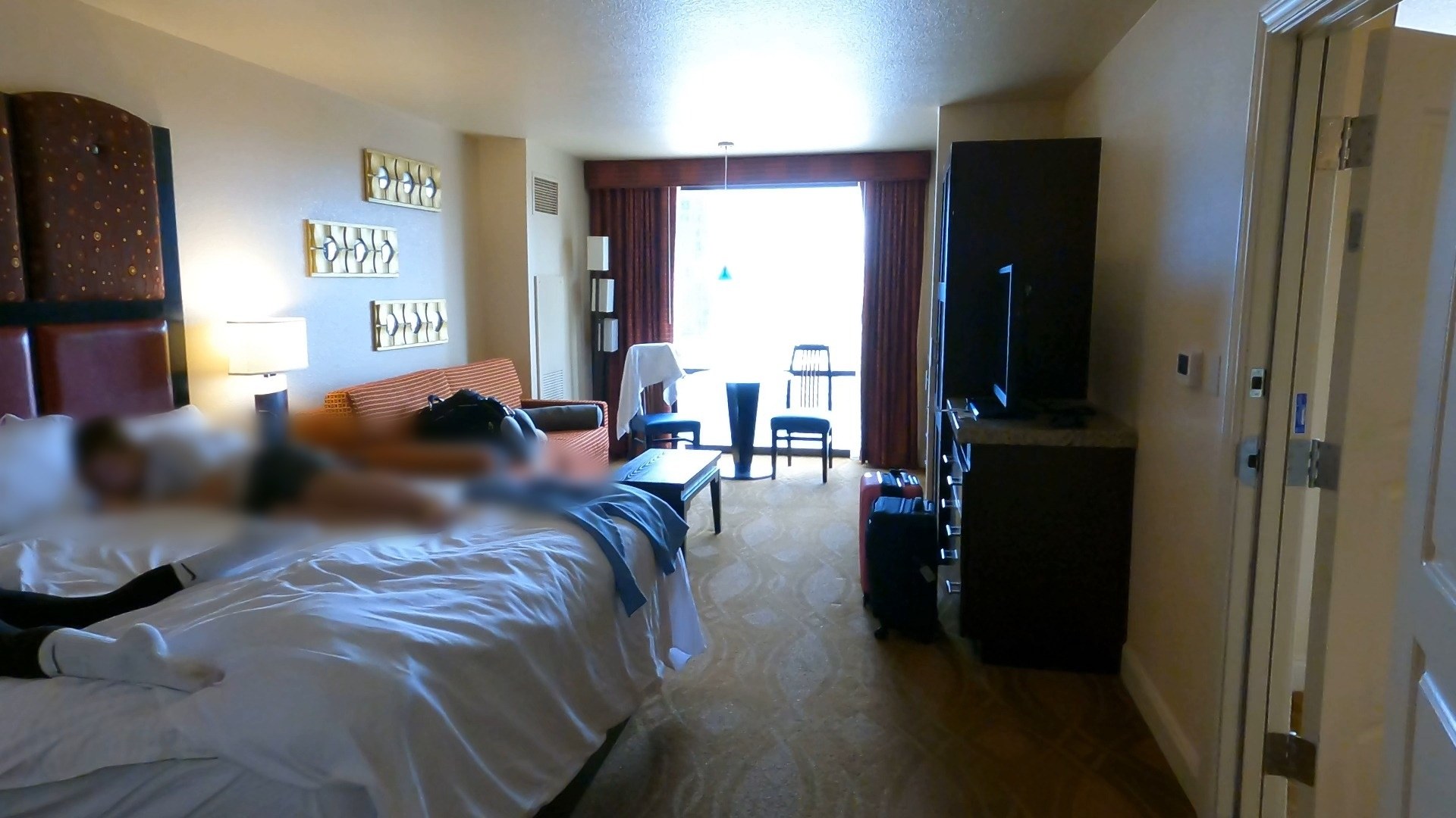 Second bedroom of the Marriott Grand Chateau two-bedroom suite with a bed and balcony window