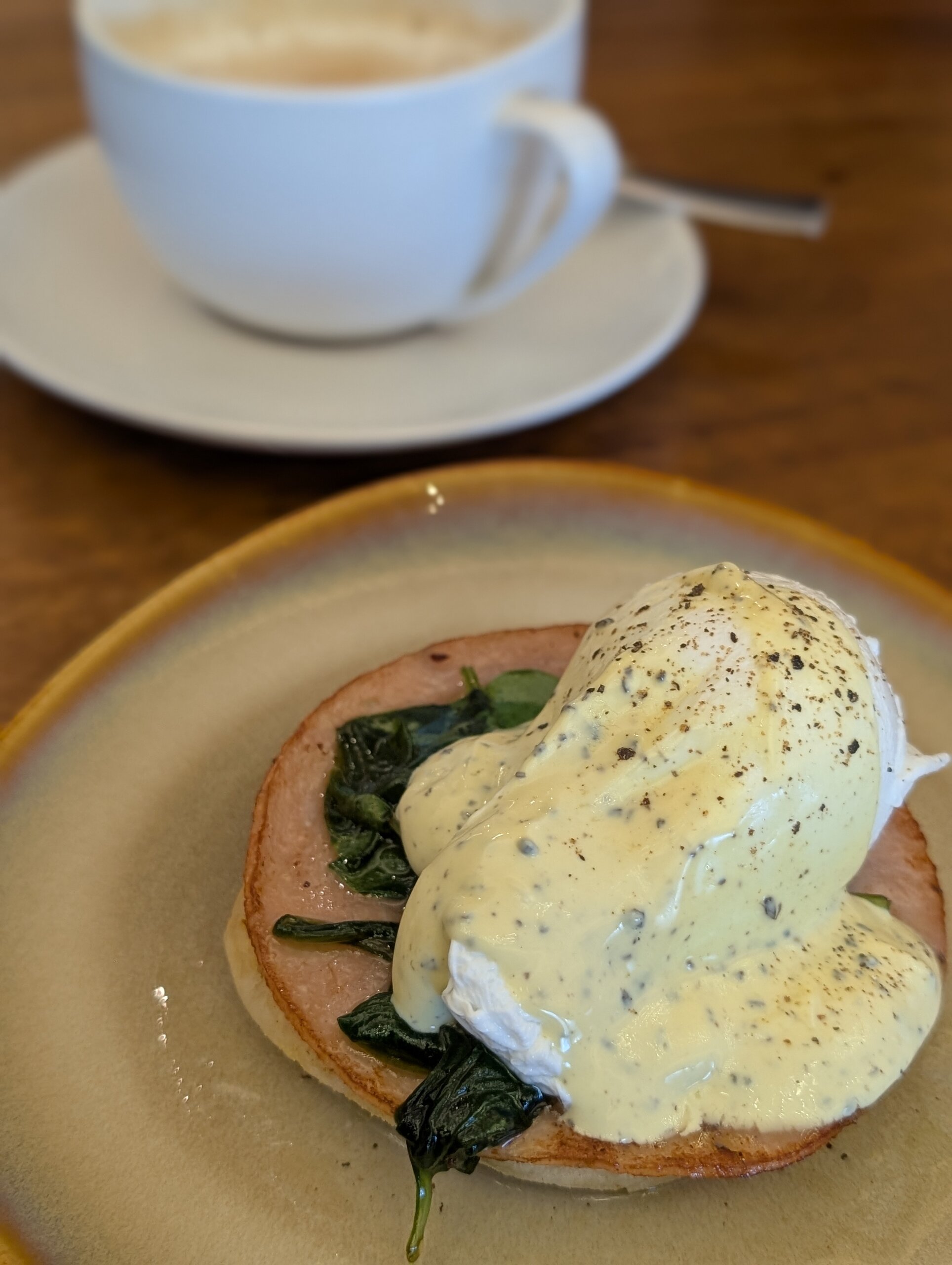 Eggs benedict over spinach with coffee in the M Club lounge at the Singapore Marriott Tang Plaza