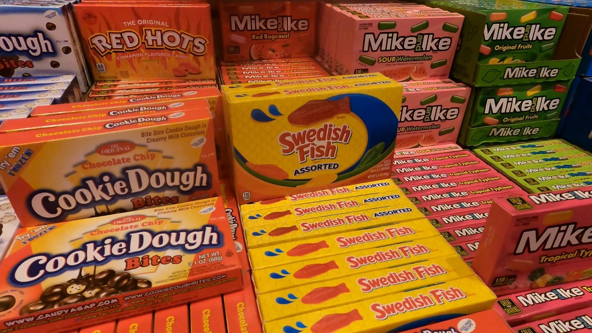 American candy shelf at Omega Mart stocked with Mike and Ike, Swedish Fish, Cookie Dough Bites and Red Hots