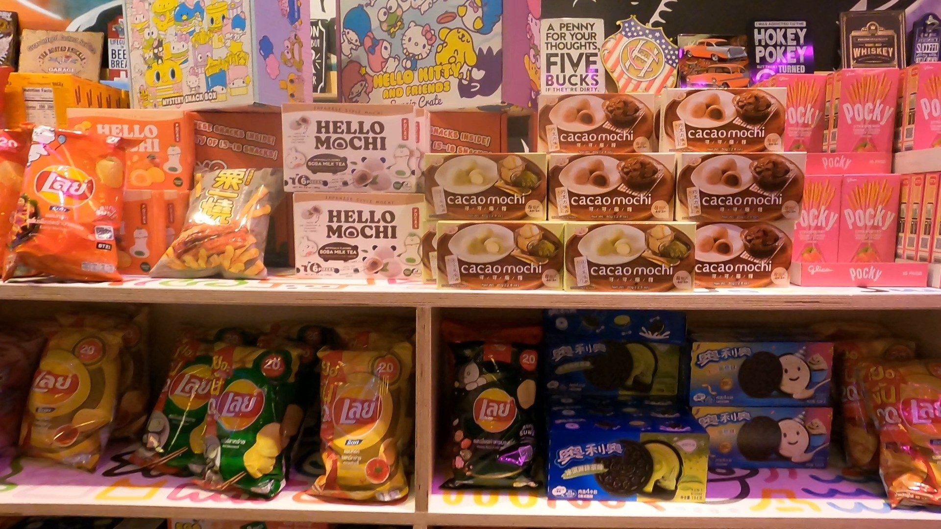 Asian and imported snack shelf at Omega Mart with Hello Mochi, Pocky and chip varieties inside Area 15
