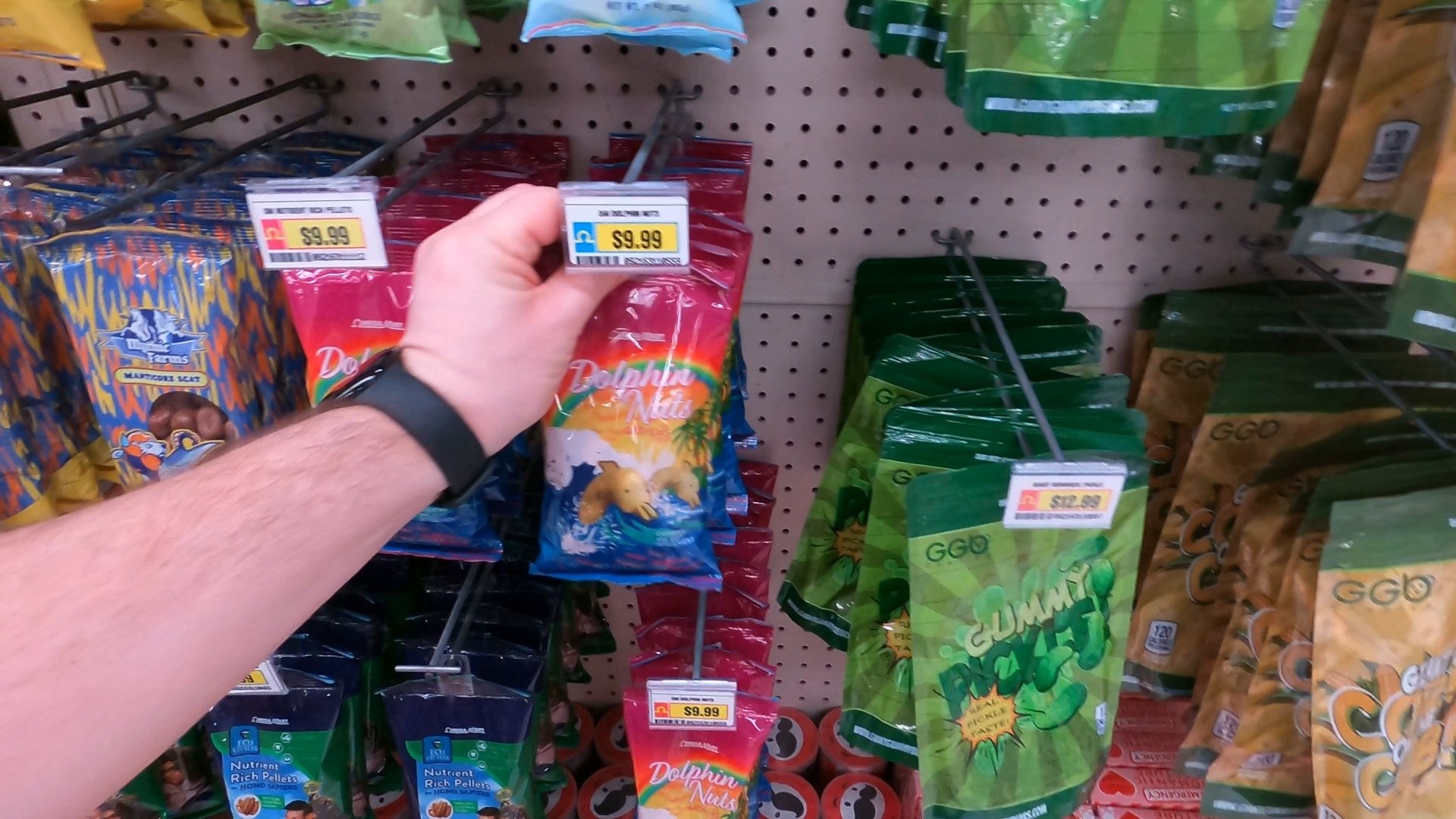 Hand holding a fake Dolphin Nuts product at the Omega Mart parody supermarket