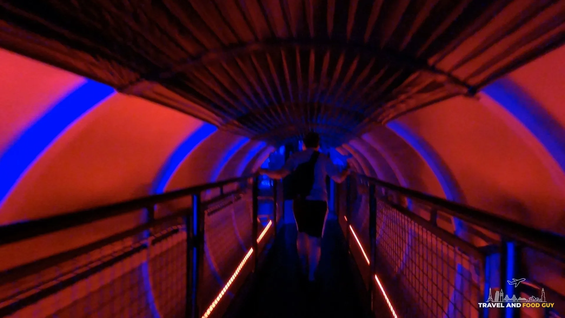 Red and blue ribbed tunnel walkway inside Omega Mart at Area 15