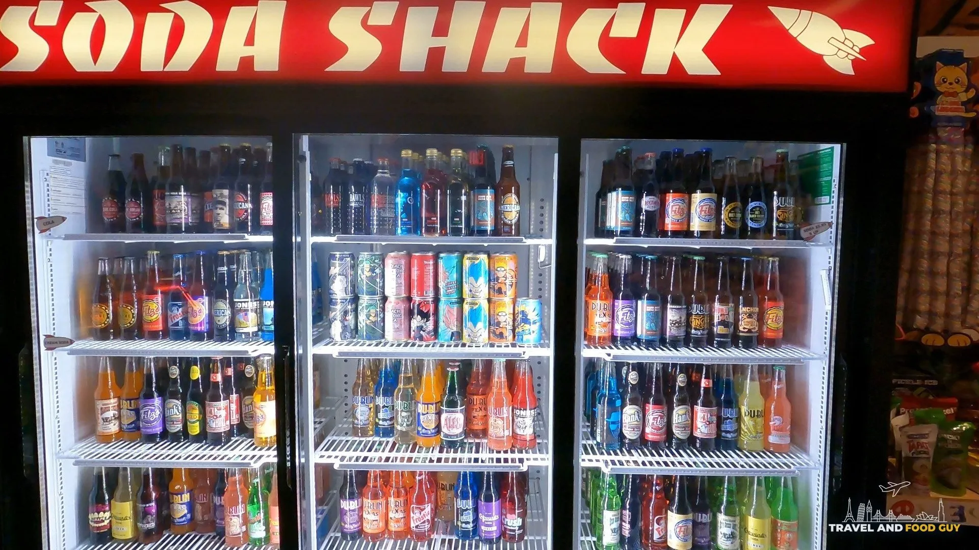 Soda Shack glass bottle wall at Omega Mart with rows of vintage and novelty sodas inside Area 15