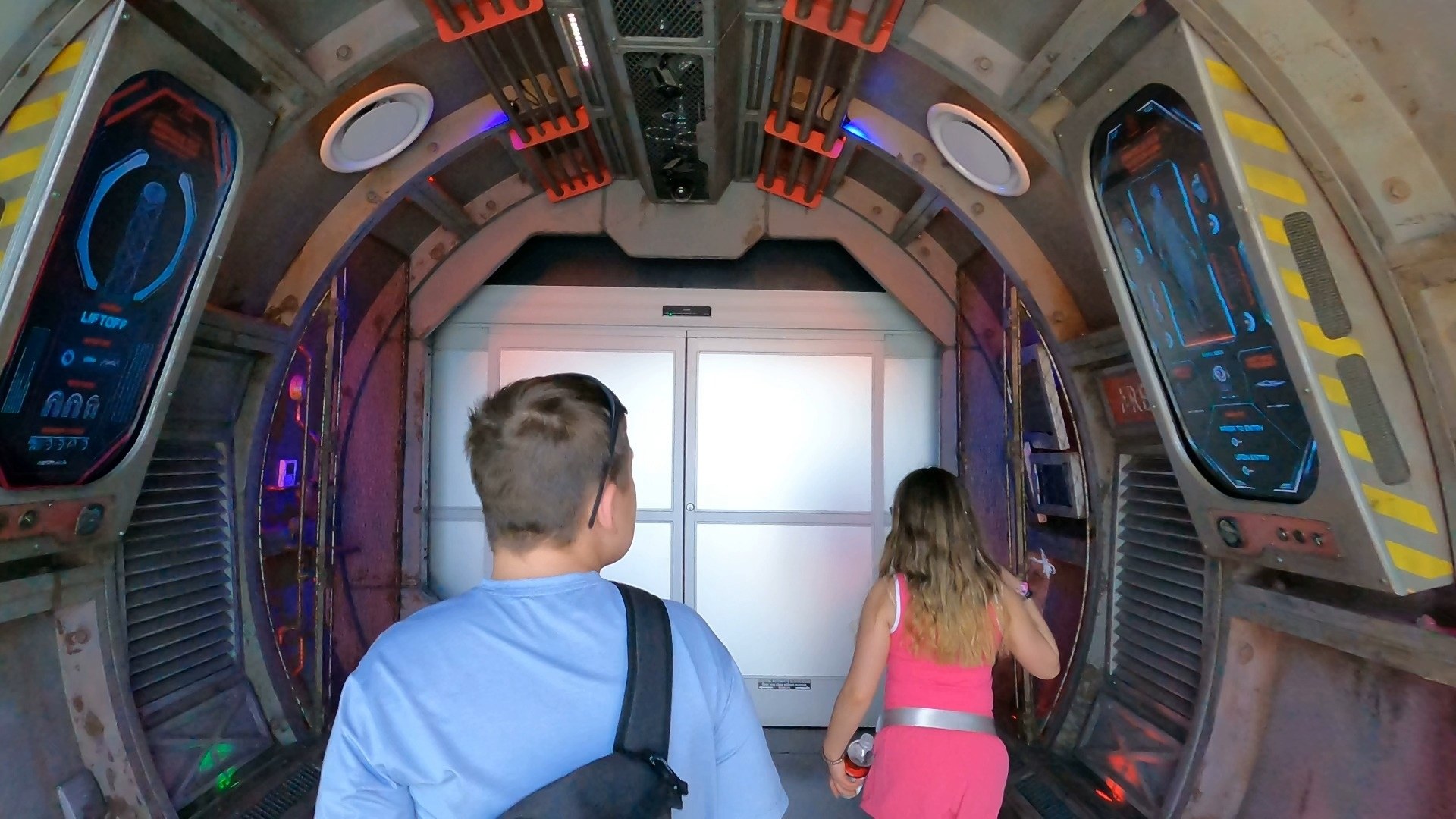 Walking through the futuristic corridor entrance to Omega Mart by Meow Wolf at Area 15