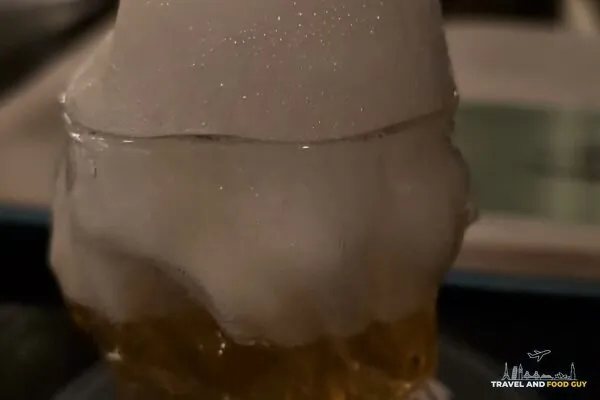 Close-up of the Saz-Air-Ak at Origin Grill and Bar with absinthe air foam piled on top of the glass.