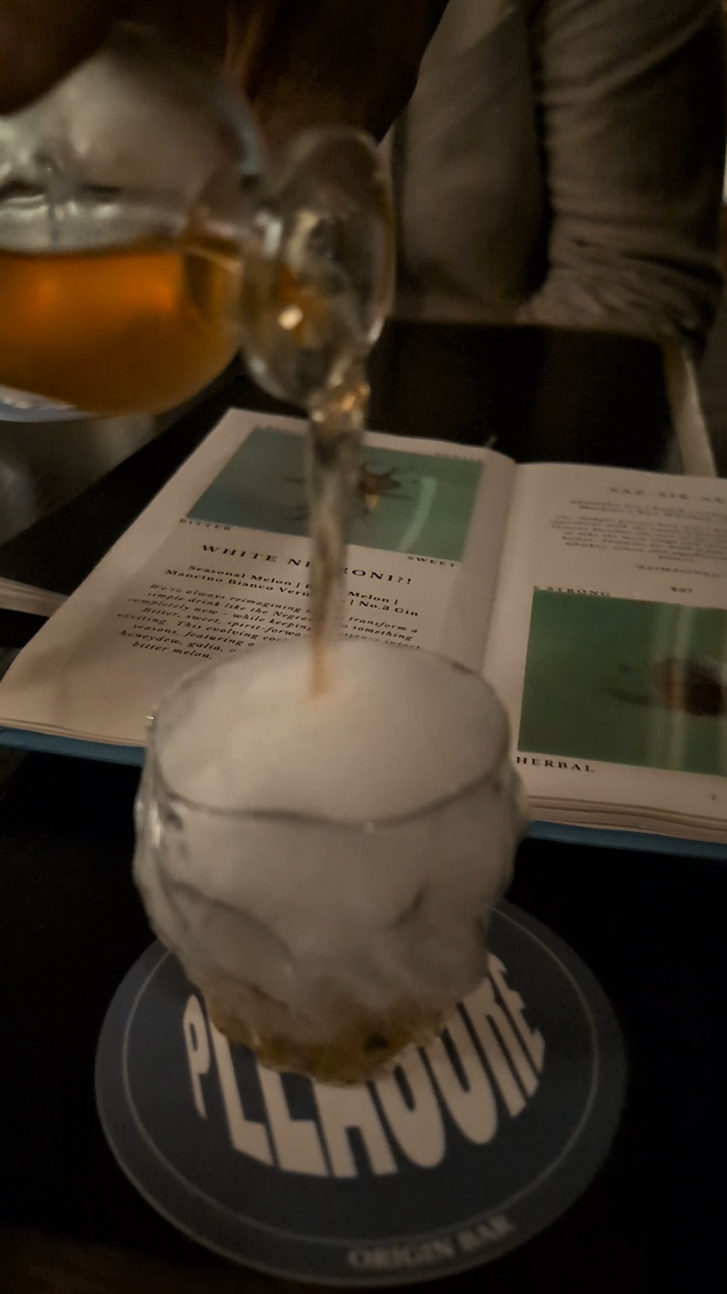Bartender pouring the Saz-Air-Ak Sazerac through absinthe-air foam over the open POV menu.