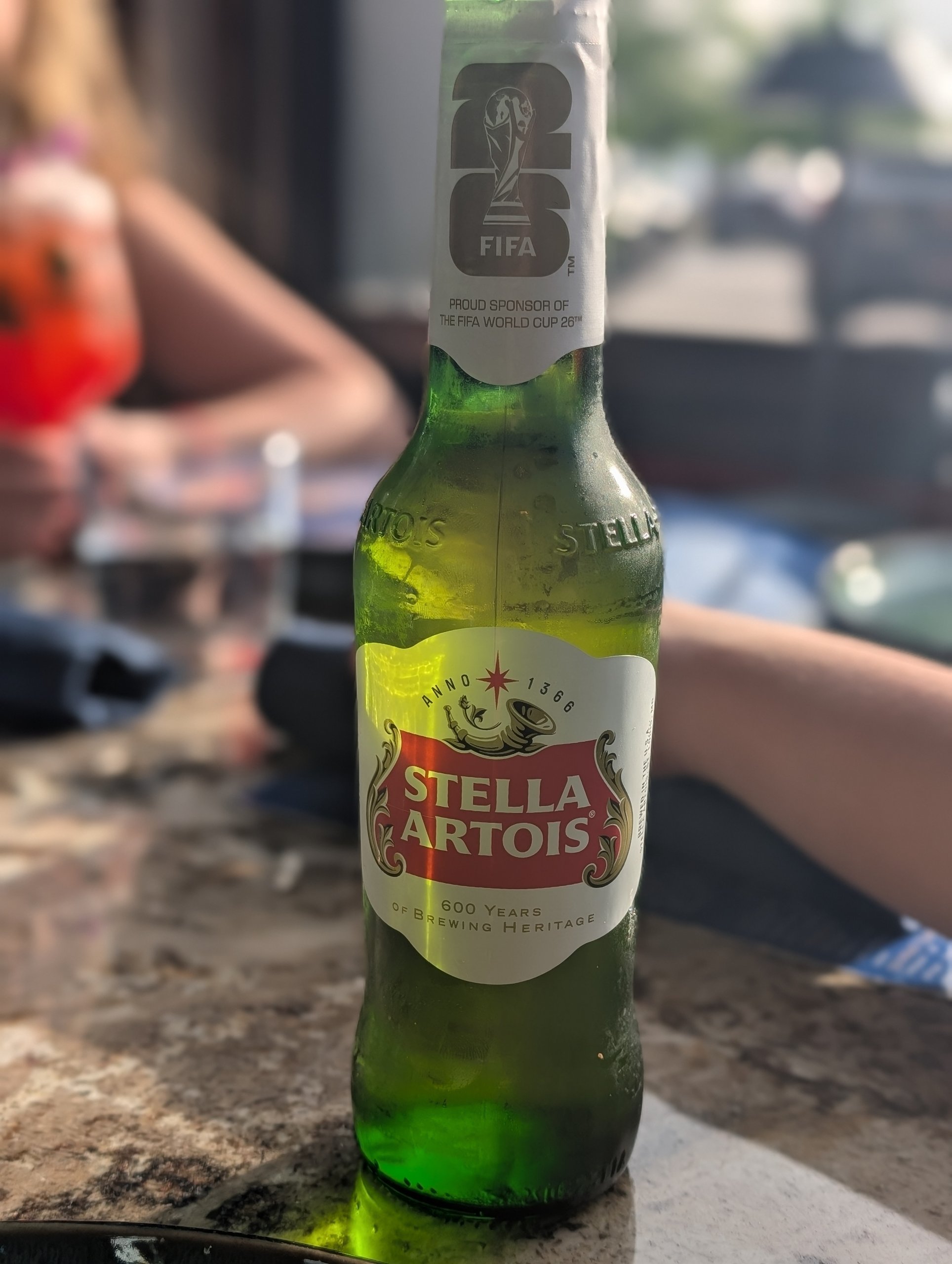 Stella Artois bottle on a marble bar top at Ostras Lounge