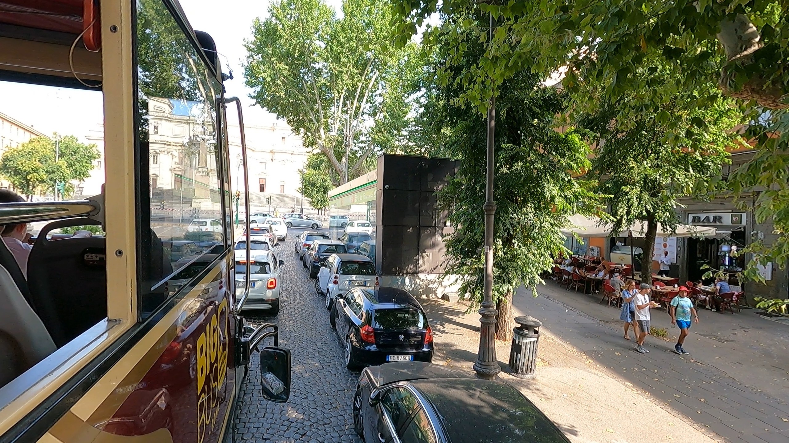 View from the upper deck of the Rome Hop-On / Hop-Off bus over a cobblestone street
