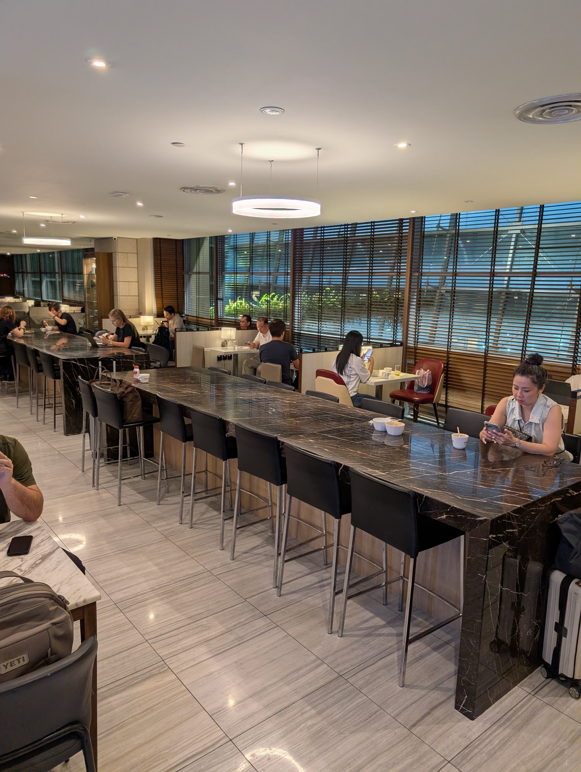 Long high top bar counter along the windows at the SATS Premier Lounge Changi T2