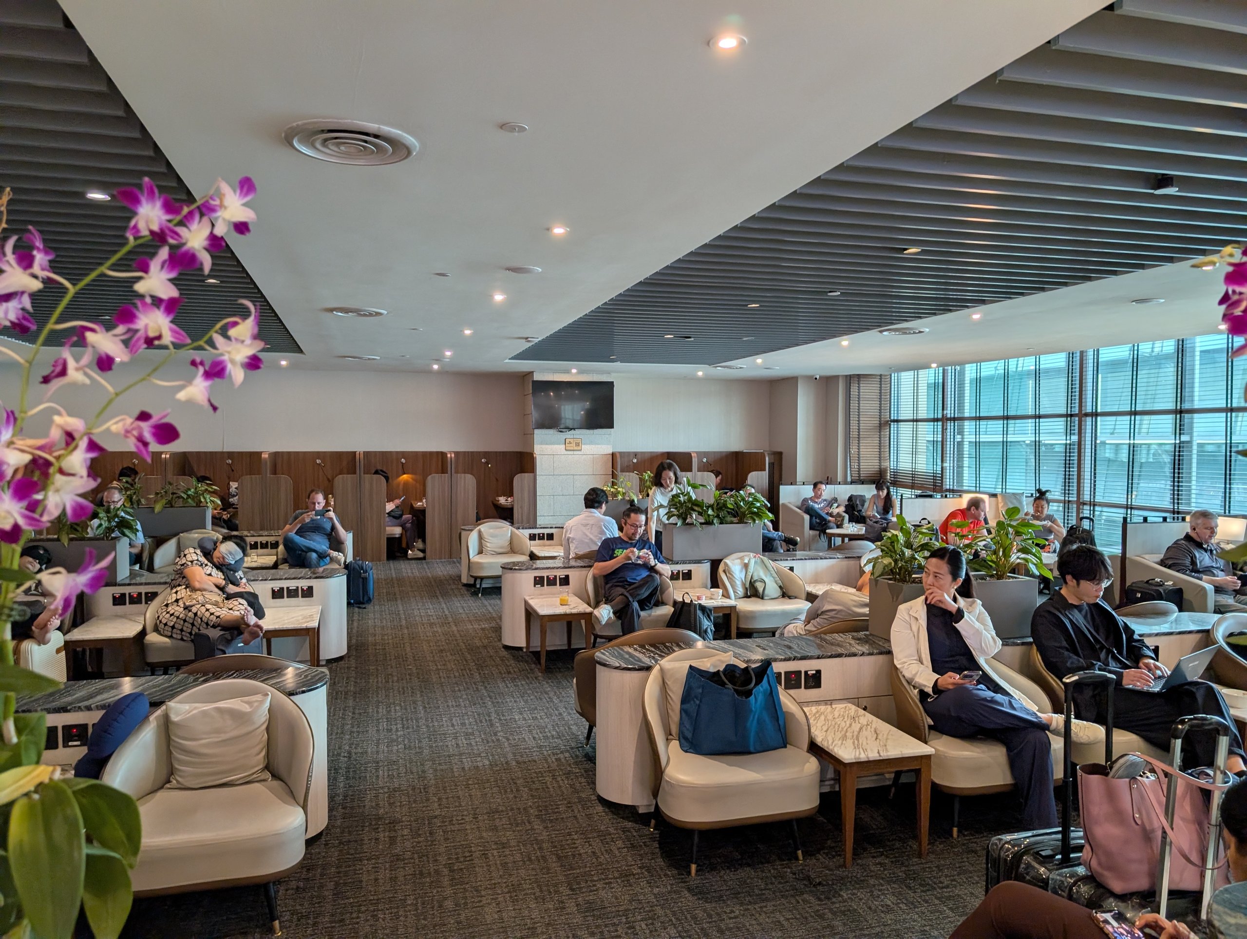 Wide shot of the main seating room with natural window light at the SATS Premier Lounge Changi T2