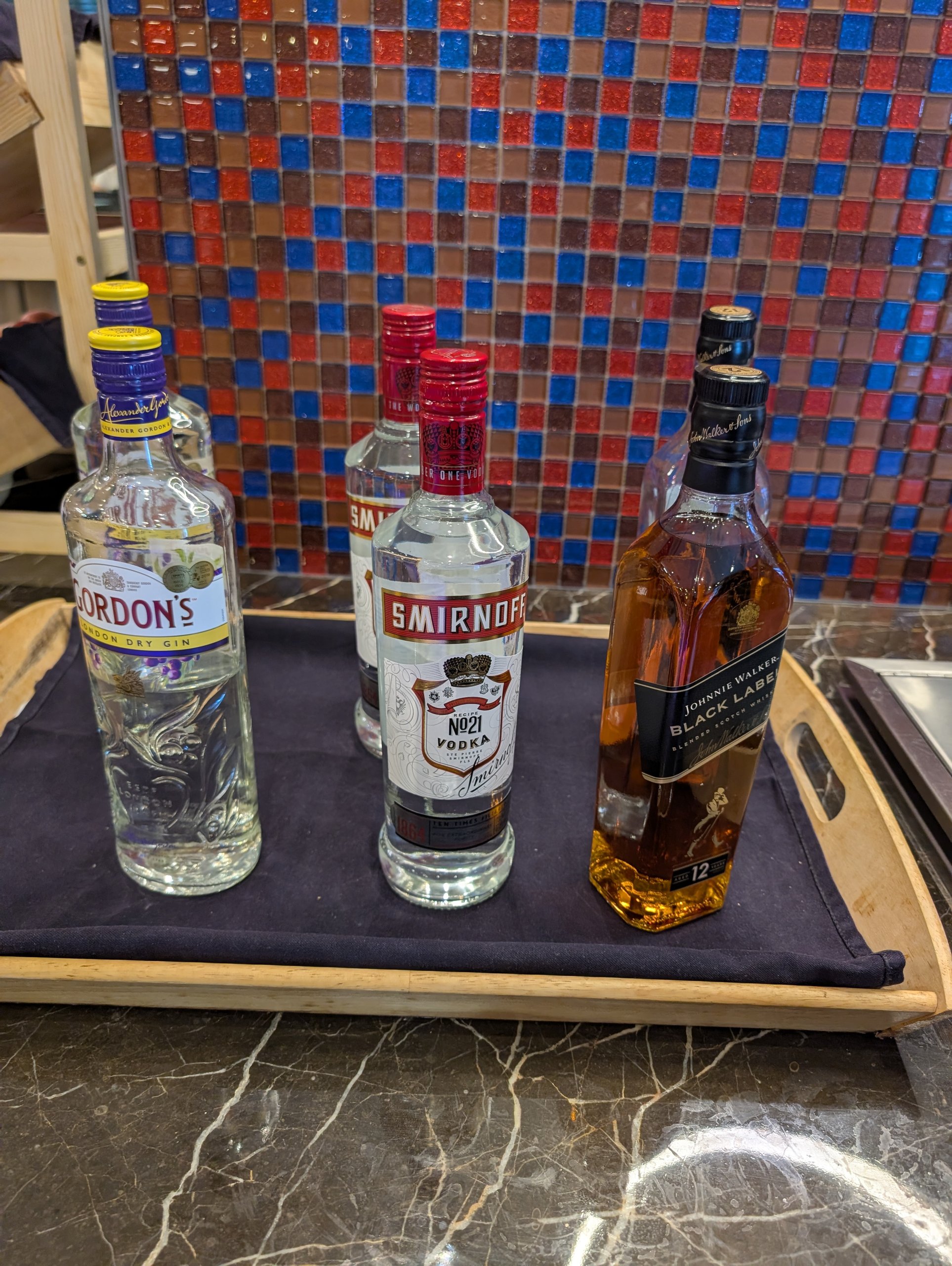 Self pour spirits tray with Gordon's gin, Smirnoff vodka, and Johnnie Walker Black Label whisky at the SATS Premier Lounge Changi T2