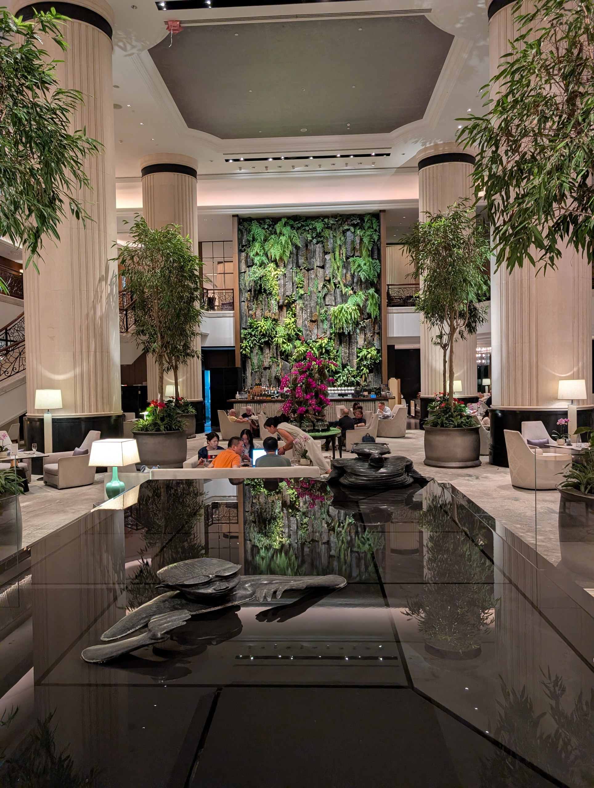 Living green wall and black-stone reflecting pool in the Shangri-La Singapore lobby.