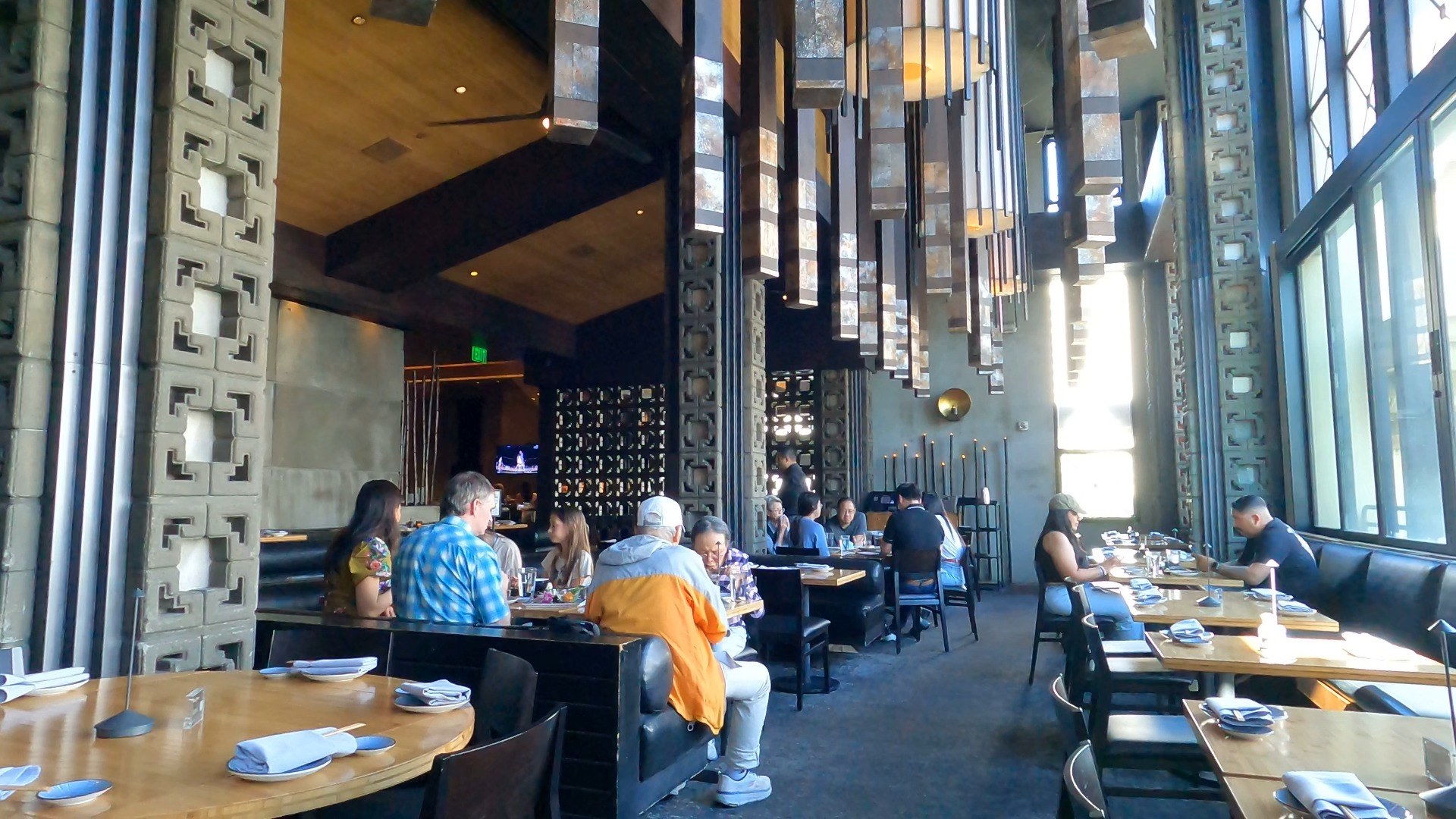Sushi Roku Las Vegas dining room with tall ceilings, hanging stone pendants, and strip-view windows