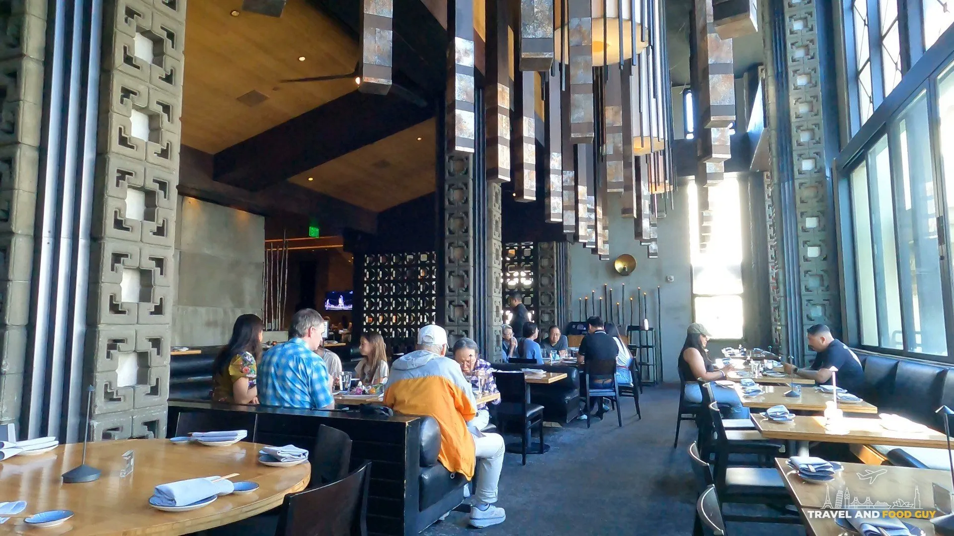 Sushi Roku Las Vegas dining room with tall ceilings, hanging stone pendants, and strip-view windows