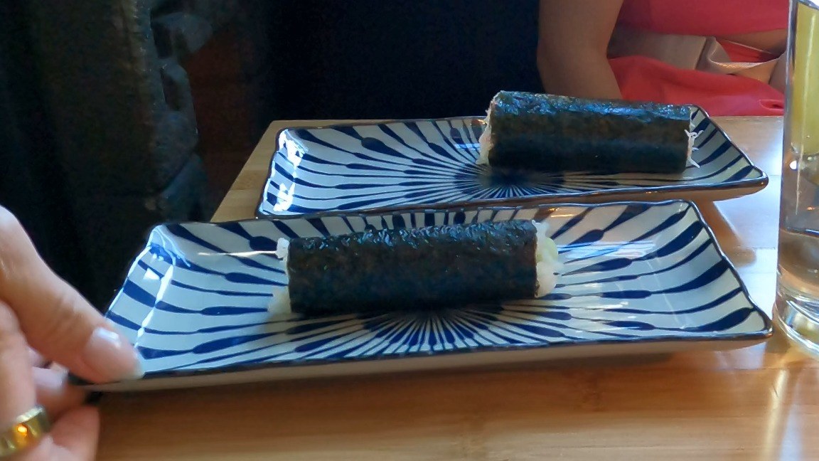 Two off-menu hand rolls on blue striped plates at Sushi Roku Las Vegas, one California and one cucumber, made for the kids