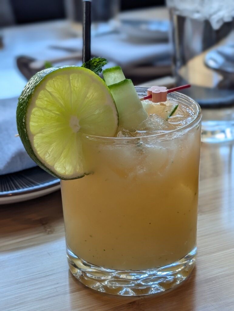 St. Cucumber cocktail at Sushi Roku Las Vegas in a rocks glass with lime wheel, cucumber ribbons, and mint garnish