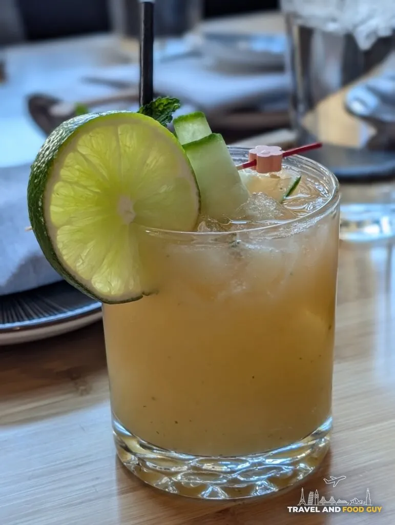 St. Cucumber cocktail at Sushi Roku Las Vegas in a rocks glass with lime wheel, cucumber ribbons, and mint garnish