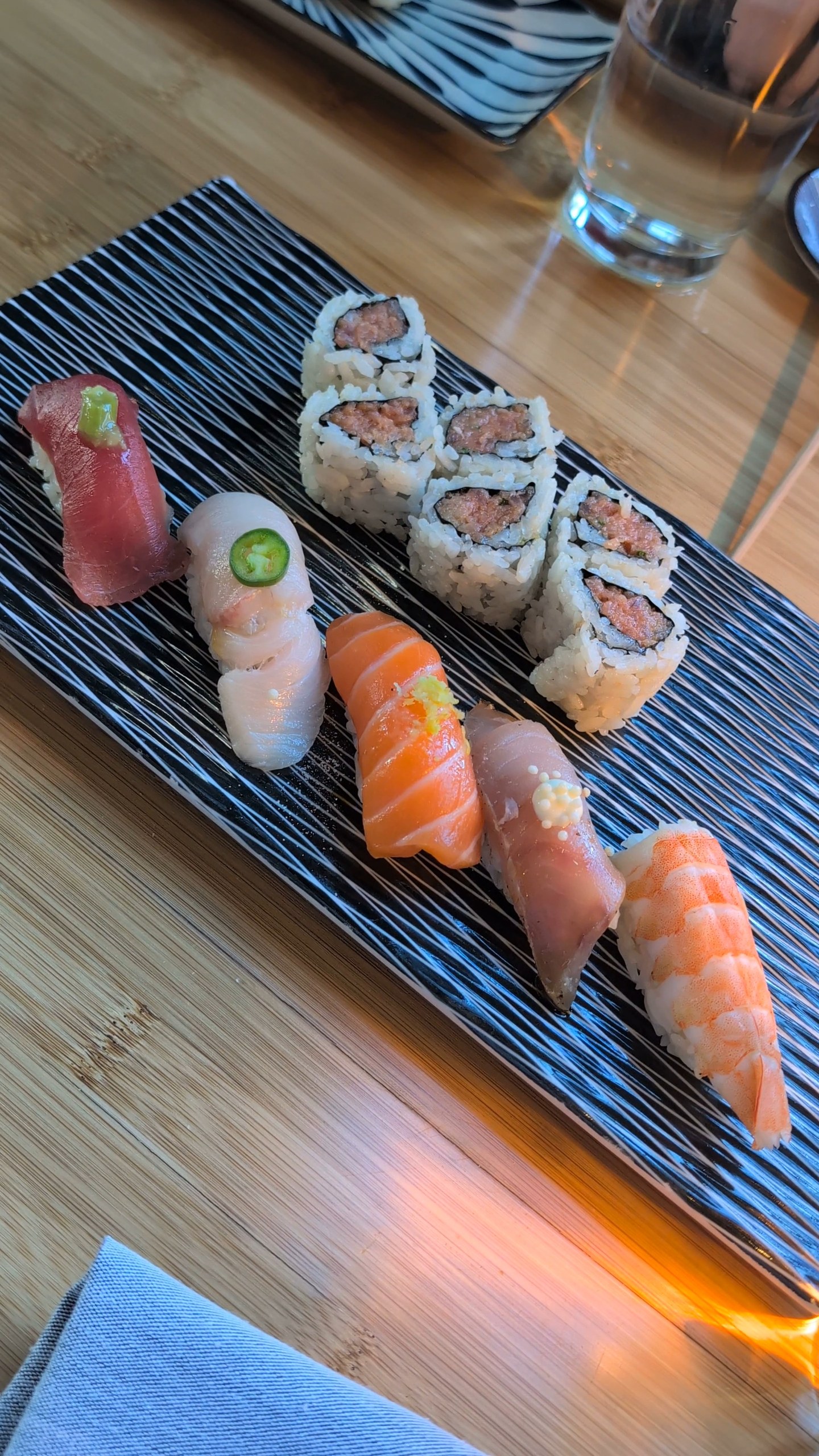 Sushi Plate at Sushi Roku Las Vegas with spicy tuna cut roll and assorted nigiri across yellowtail, tuna, salmon, shrimp, and albacore