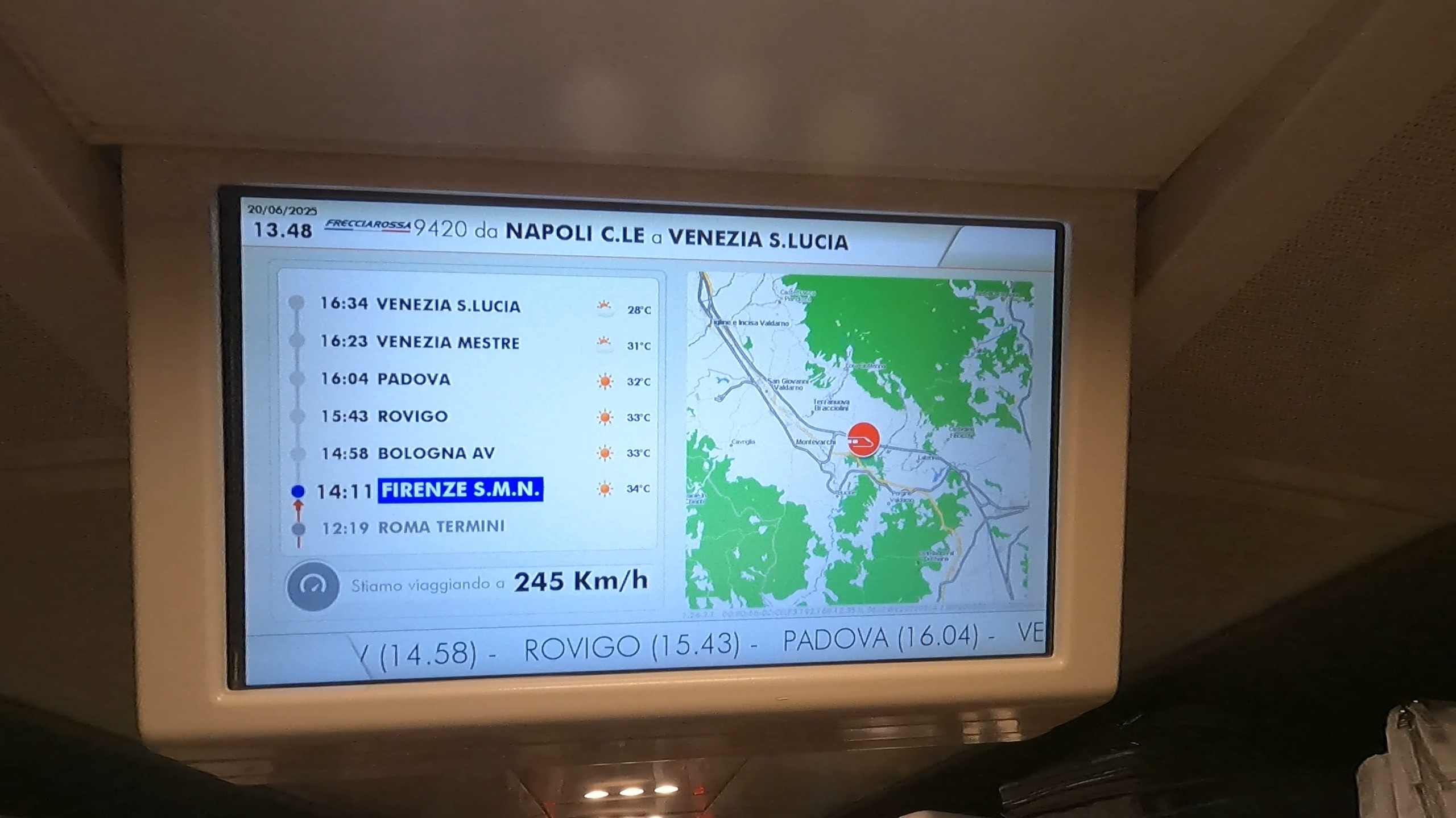Trenitalia Frecciarossa onboard monitor showing route stops and a travel speed of 245 km/h